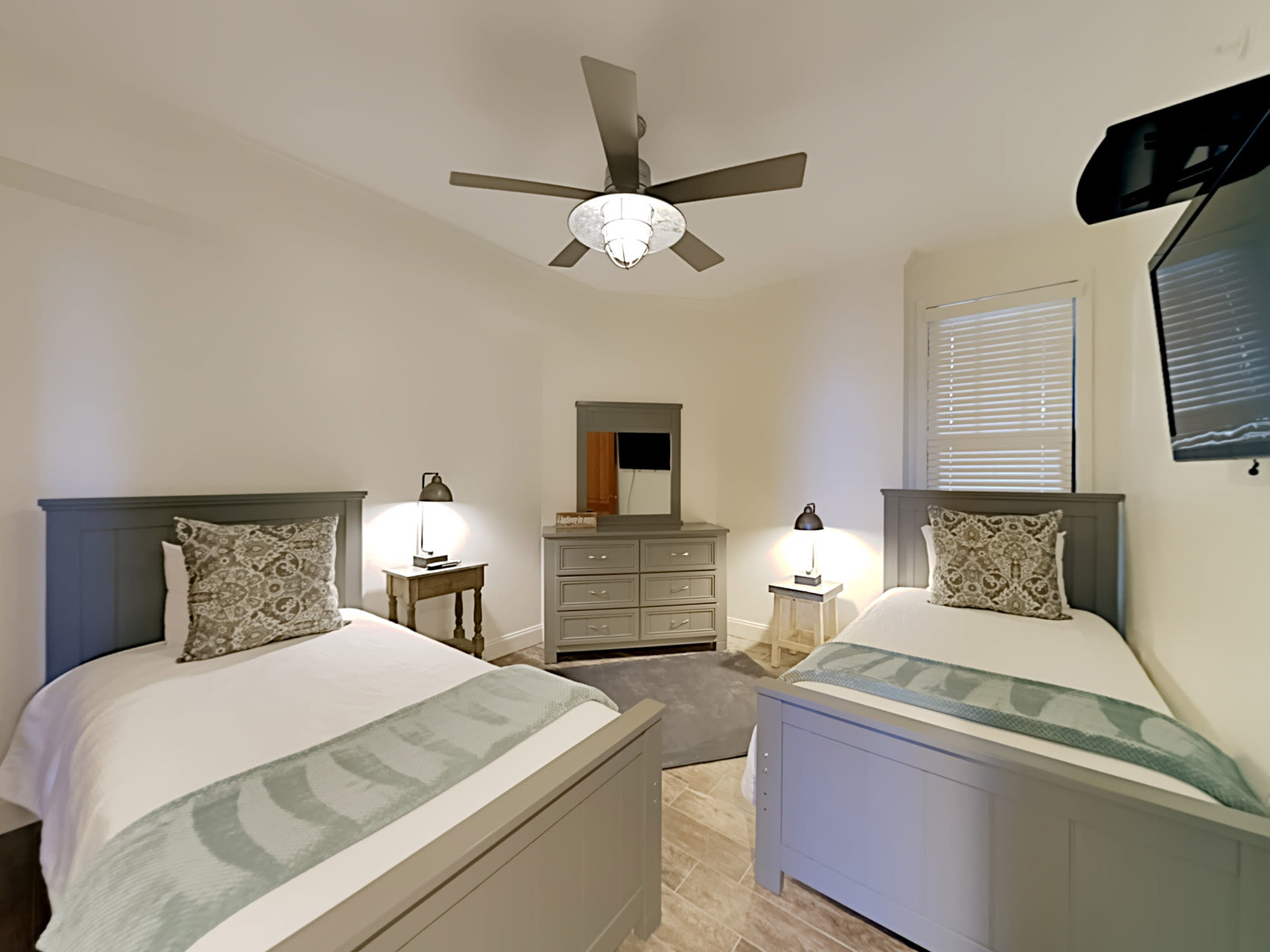 3rd bedroom has twin beds, flat screen, ceiling fan and bath with hall access.