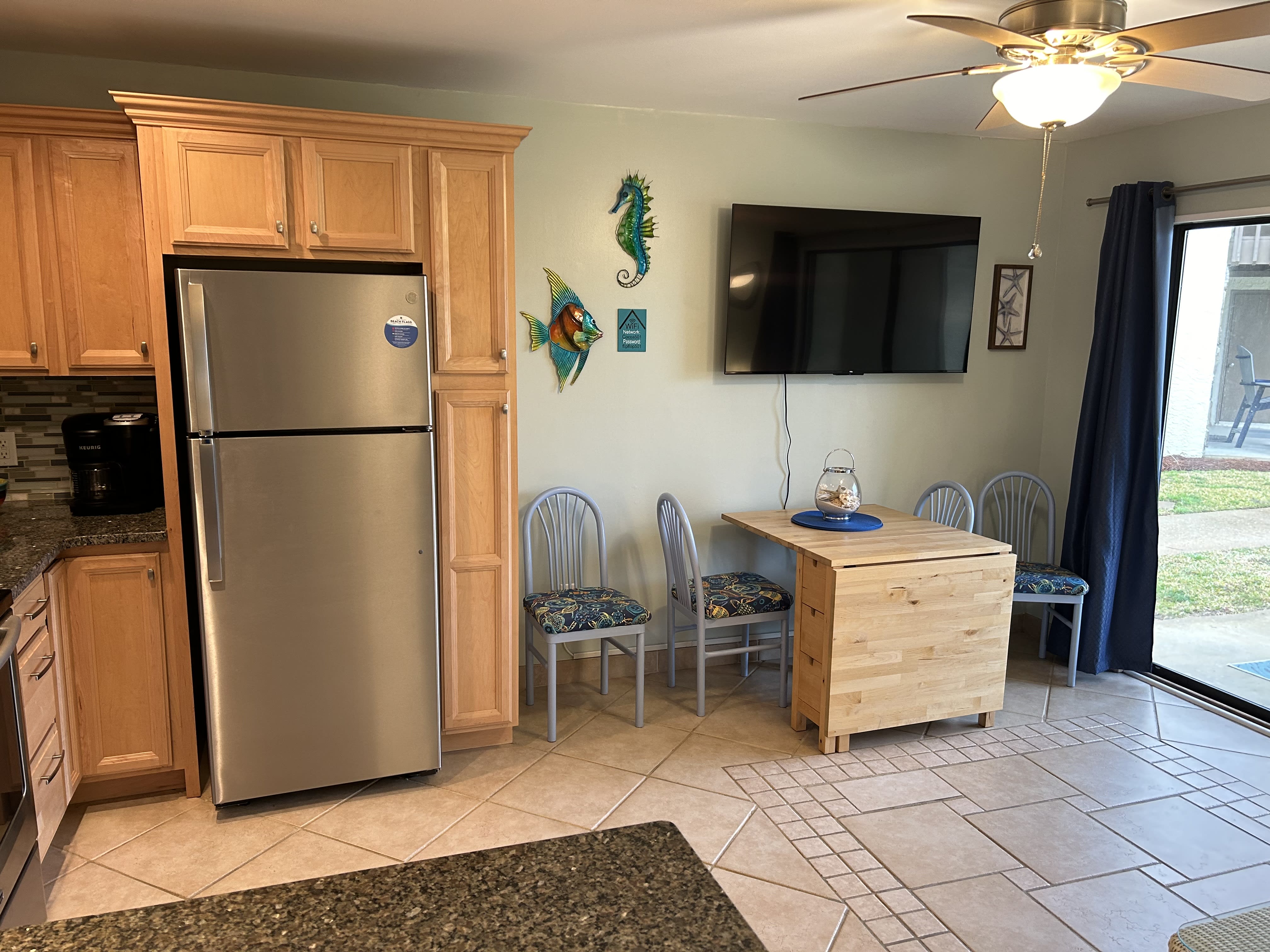 Kitchen table will seat 4, new 55" Smart TV in combination living room/kitchen