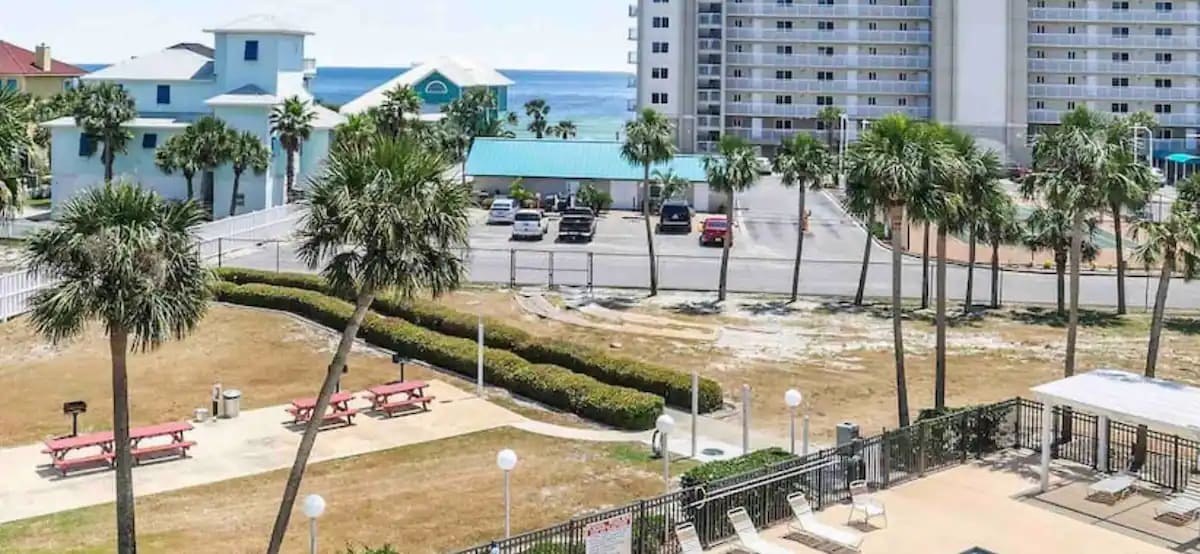 View of walkway to beach. walk between hedges, along side of vinyl fence to beach. All gated for condo guests.