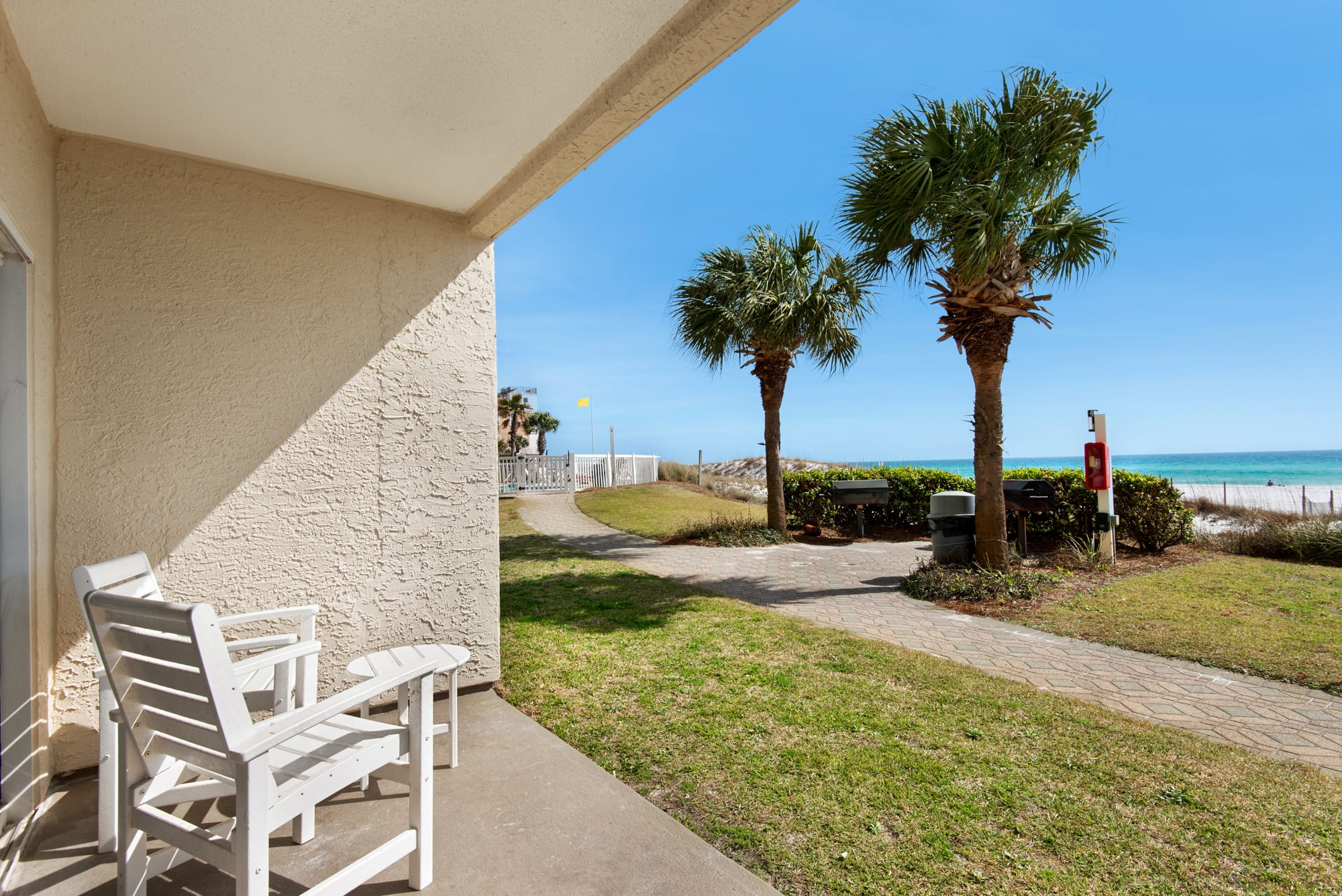 lawn area for kids to run around and steps away from gated pool