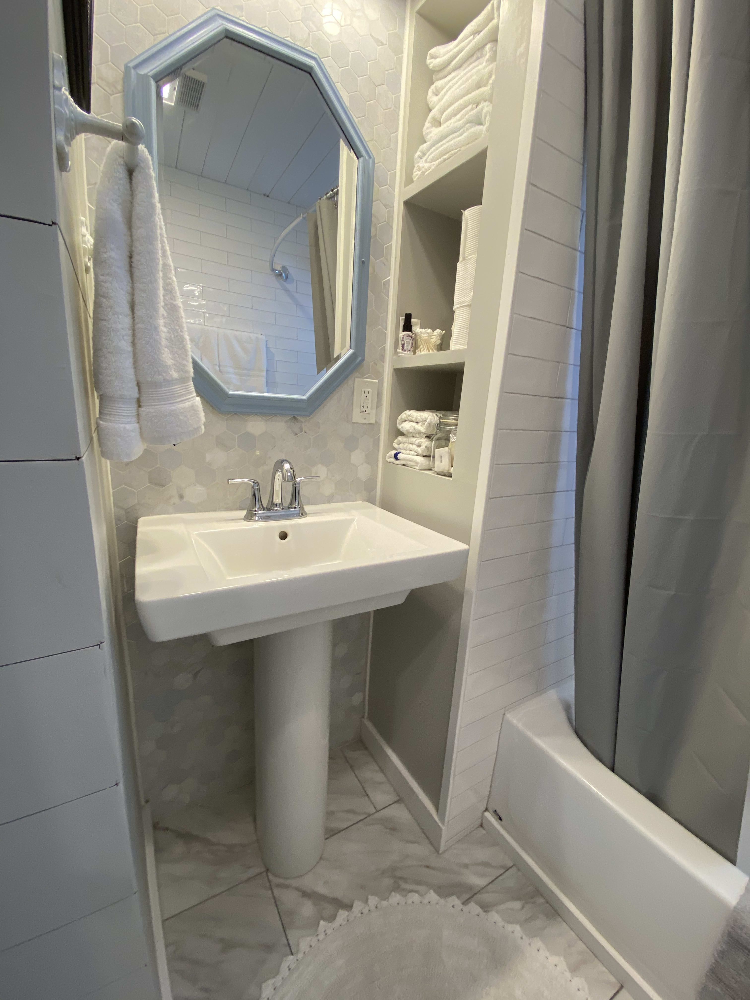 Custom tile work in the bathroom, plus fluffy white towels!