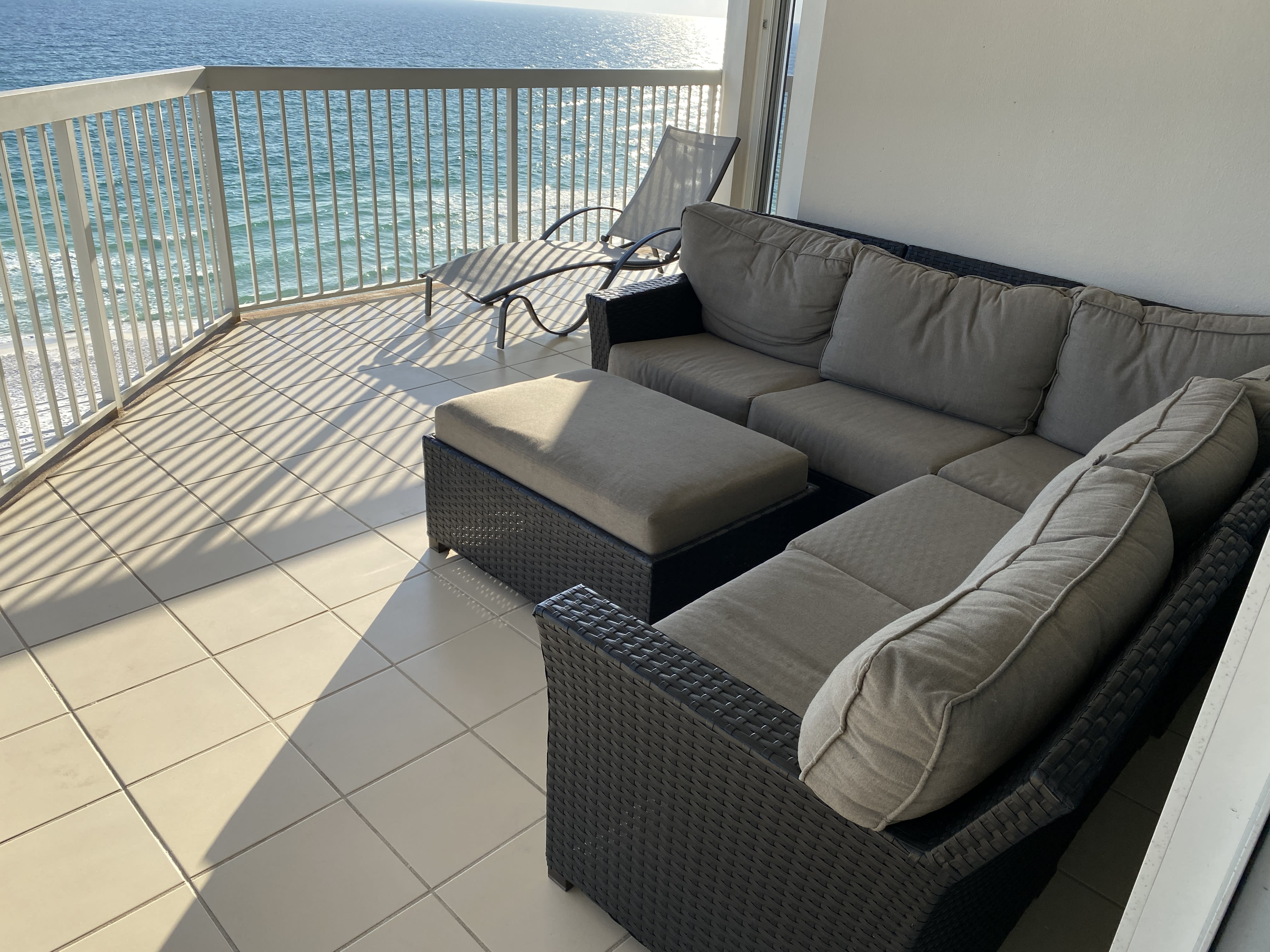 Large gulfside balcony features outdoor sectional sofa.