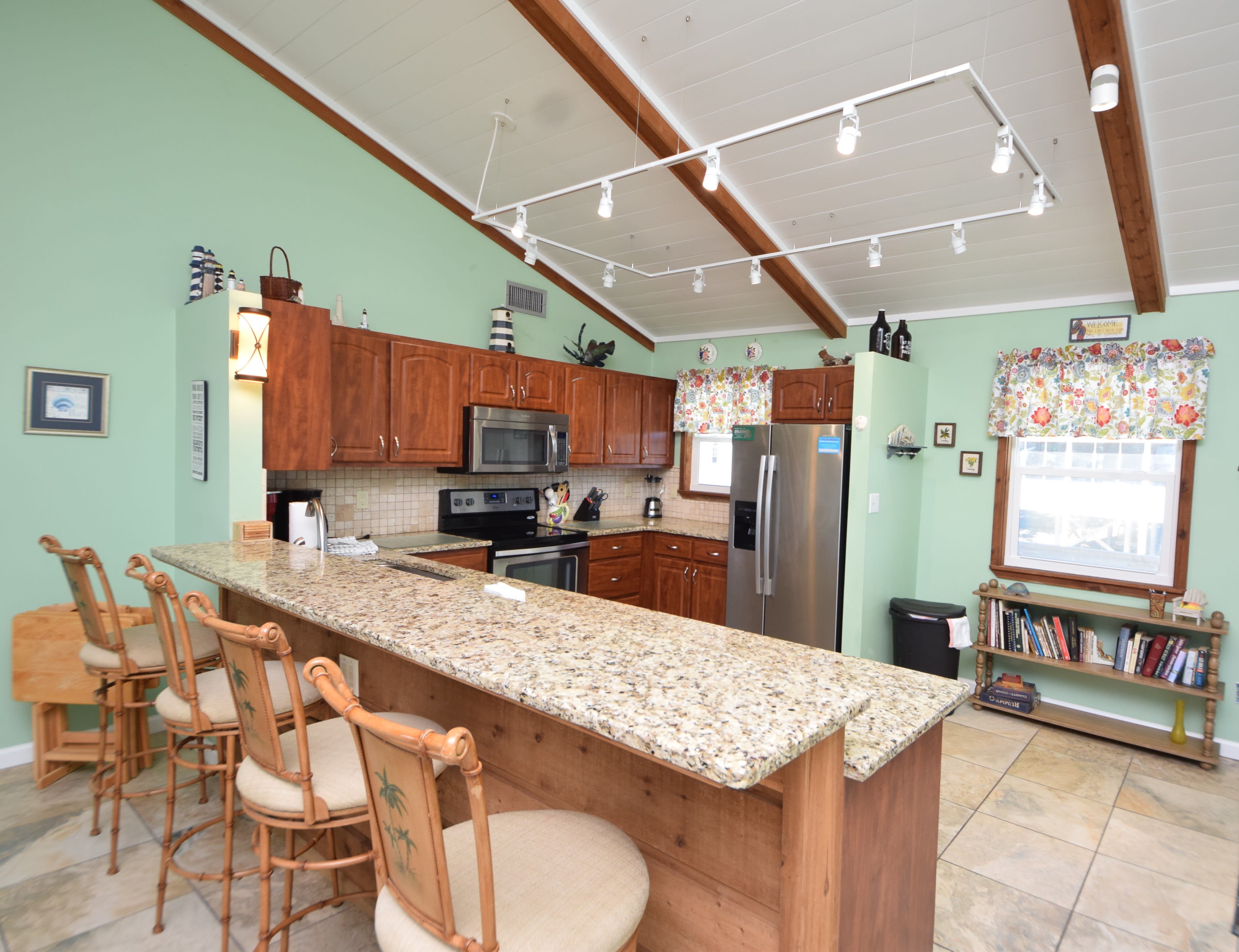 Bar top in the kitchen with barstools and outlets
