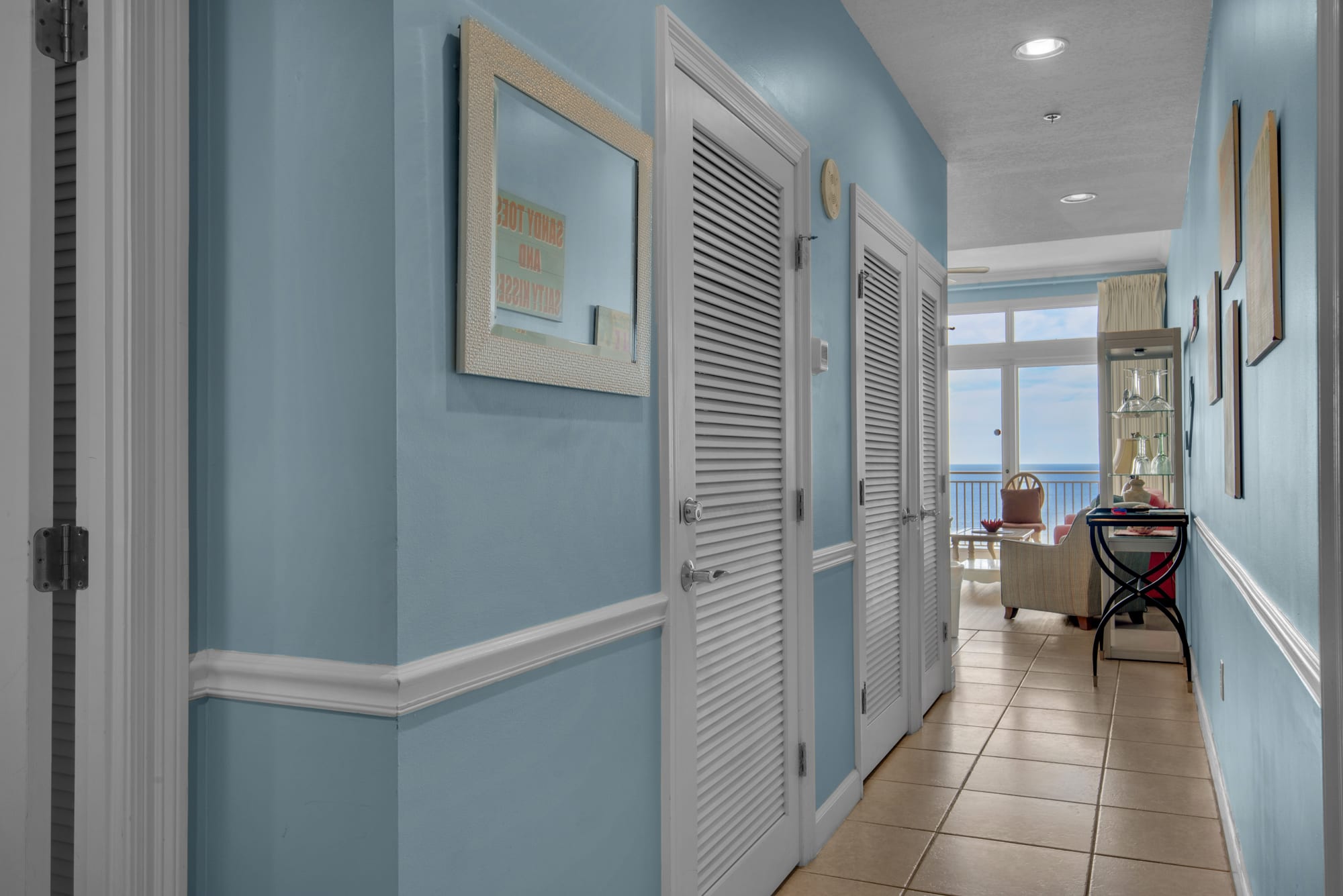 Entry hallway with in unit washer/dryer in closet on left. 
