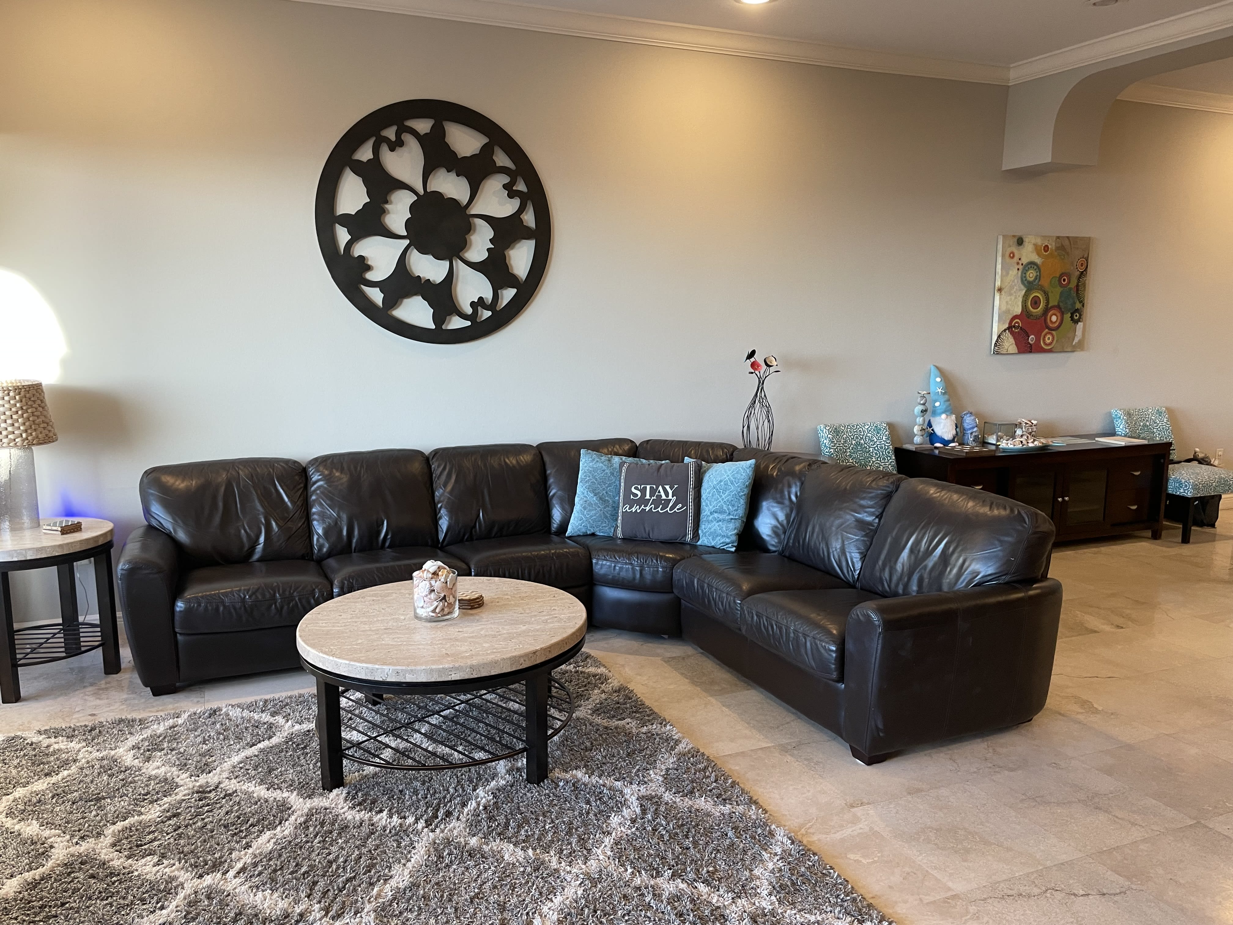 Comfortable leather couch in the living room with ocean views.