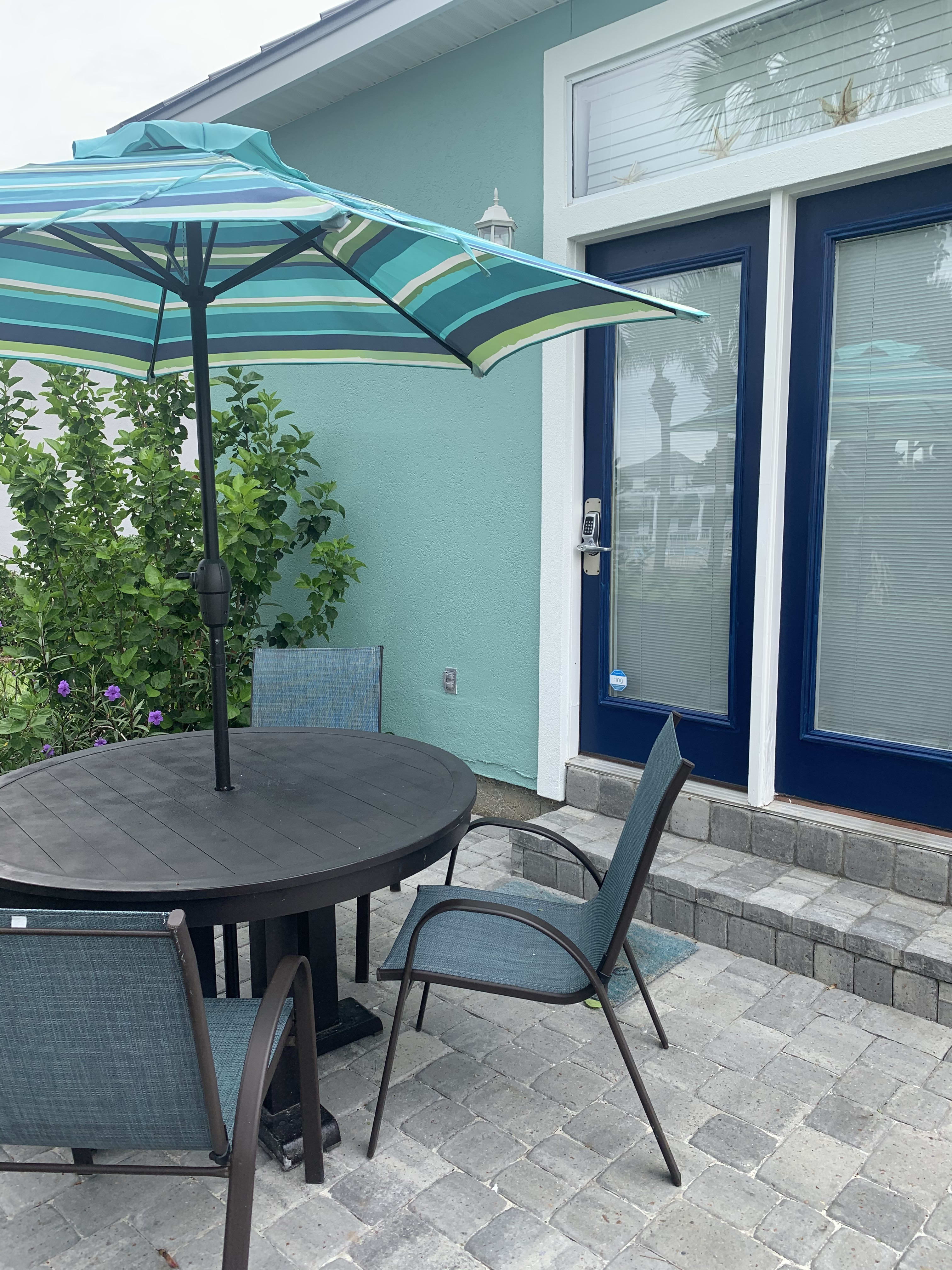 Rear patio is steps away from community pool and hot tub