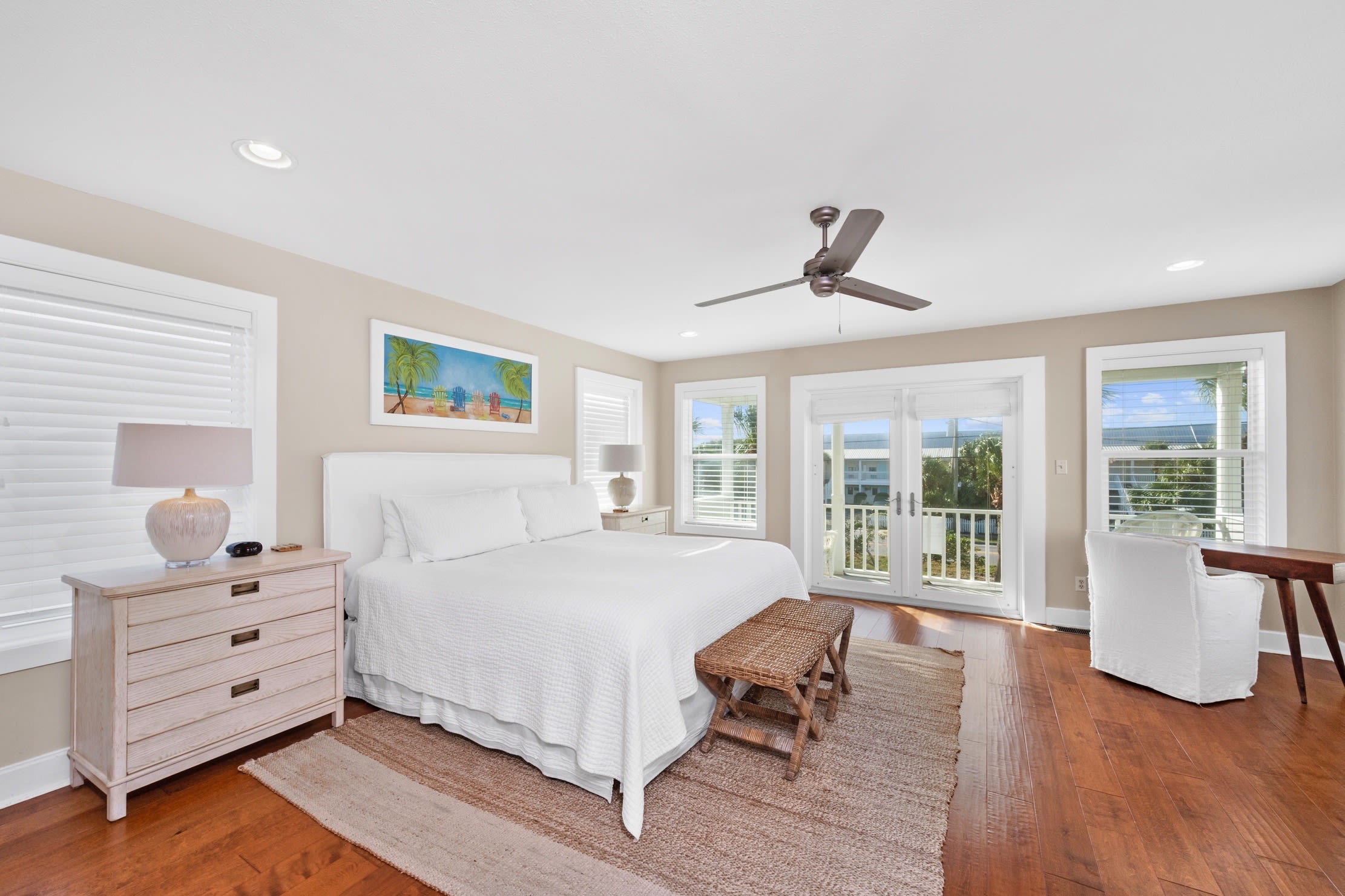 Fresh and airy master suite with comfortable king bed and deck access.