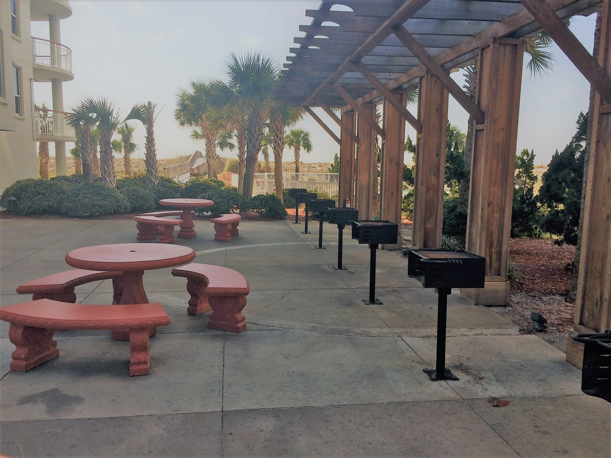 Grill area for guest use is located at the side of the condo by the pool area