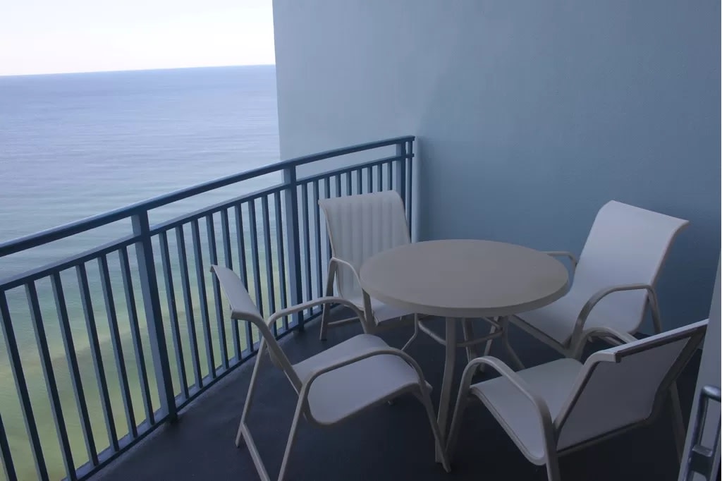 Dining and Lounging area on balcony. See pool deck, hot tub, ocean, pier.