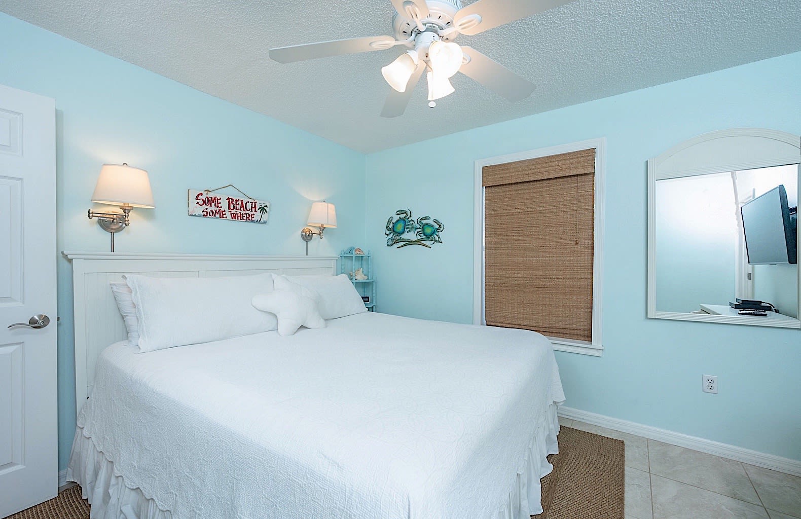 Master bedroom has comfortable king size bed, ceiling fan, and smart TV