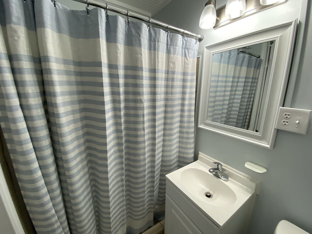 1st bathroom with fully tiled shower