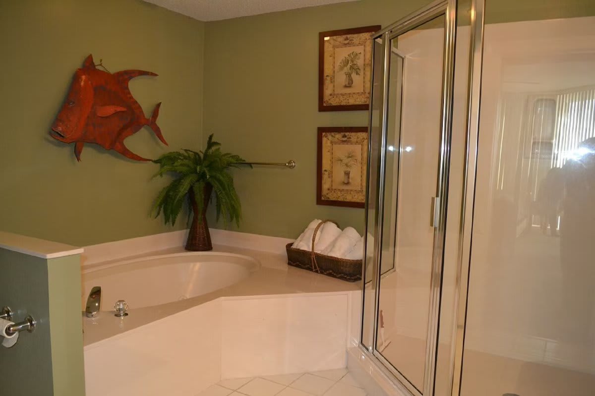 Master bath with jacuzzi tub and shower &amp; has a separate vanity area with sink.