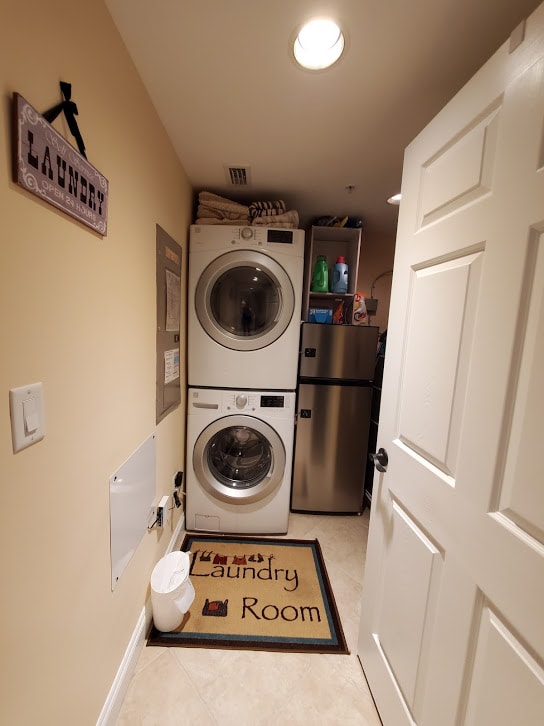 Laundry room stocked with detergent, softener, and dryer sheets.