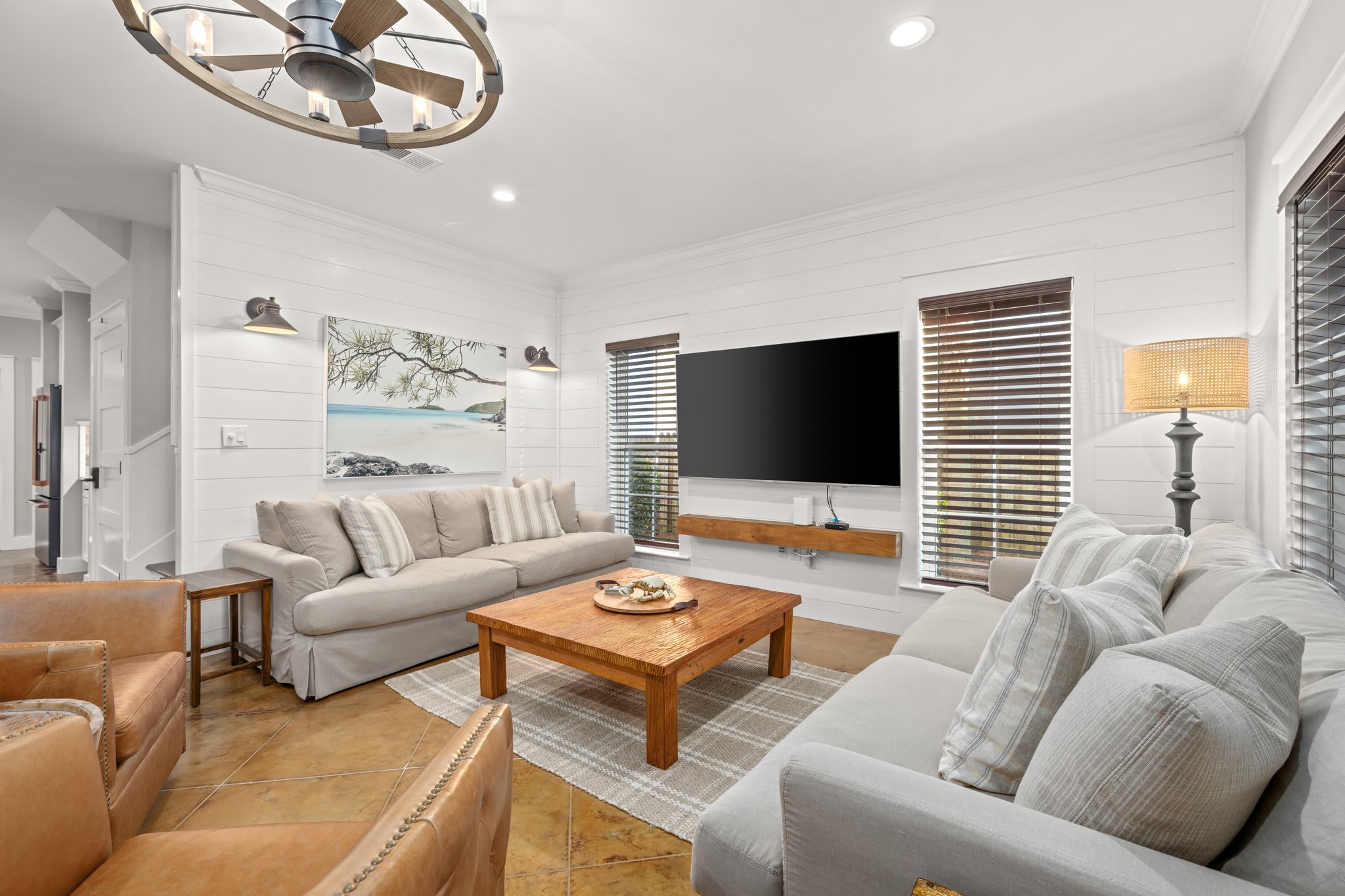 Spacious Living Room complete with massive TV, Fandalier, and swivel rockers.