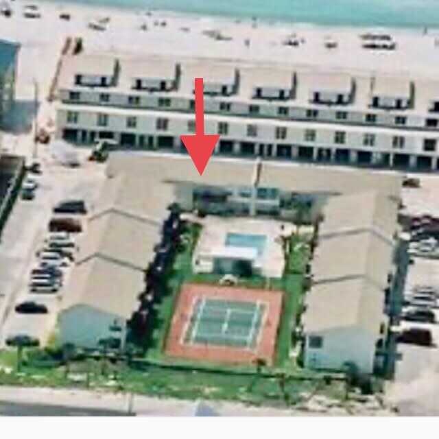 We are here on the main level. Front door goes to the beach, back patio to pool