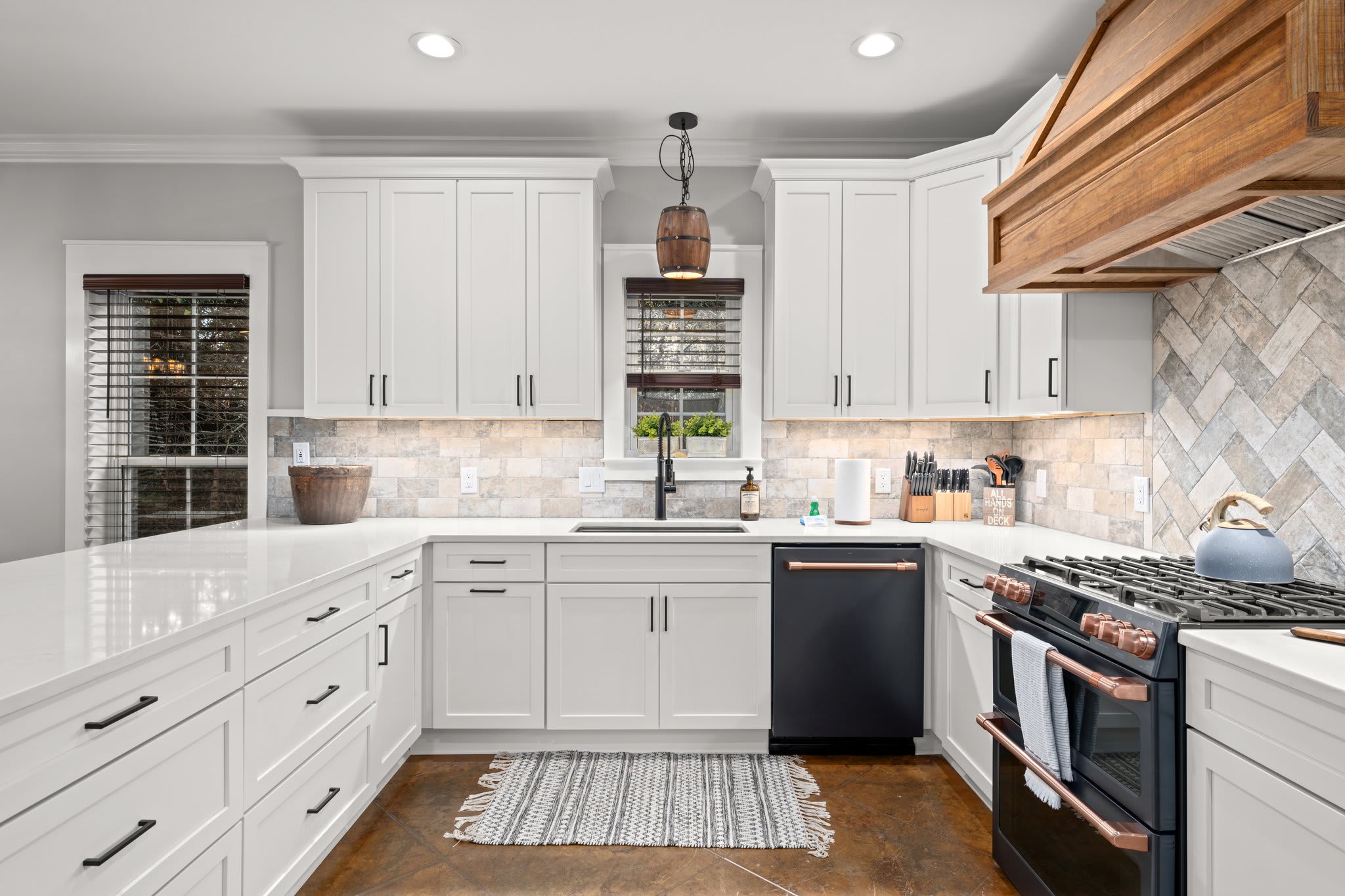 Commercial sink, double oven, gas range. Coffee Pot, and Keurig.