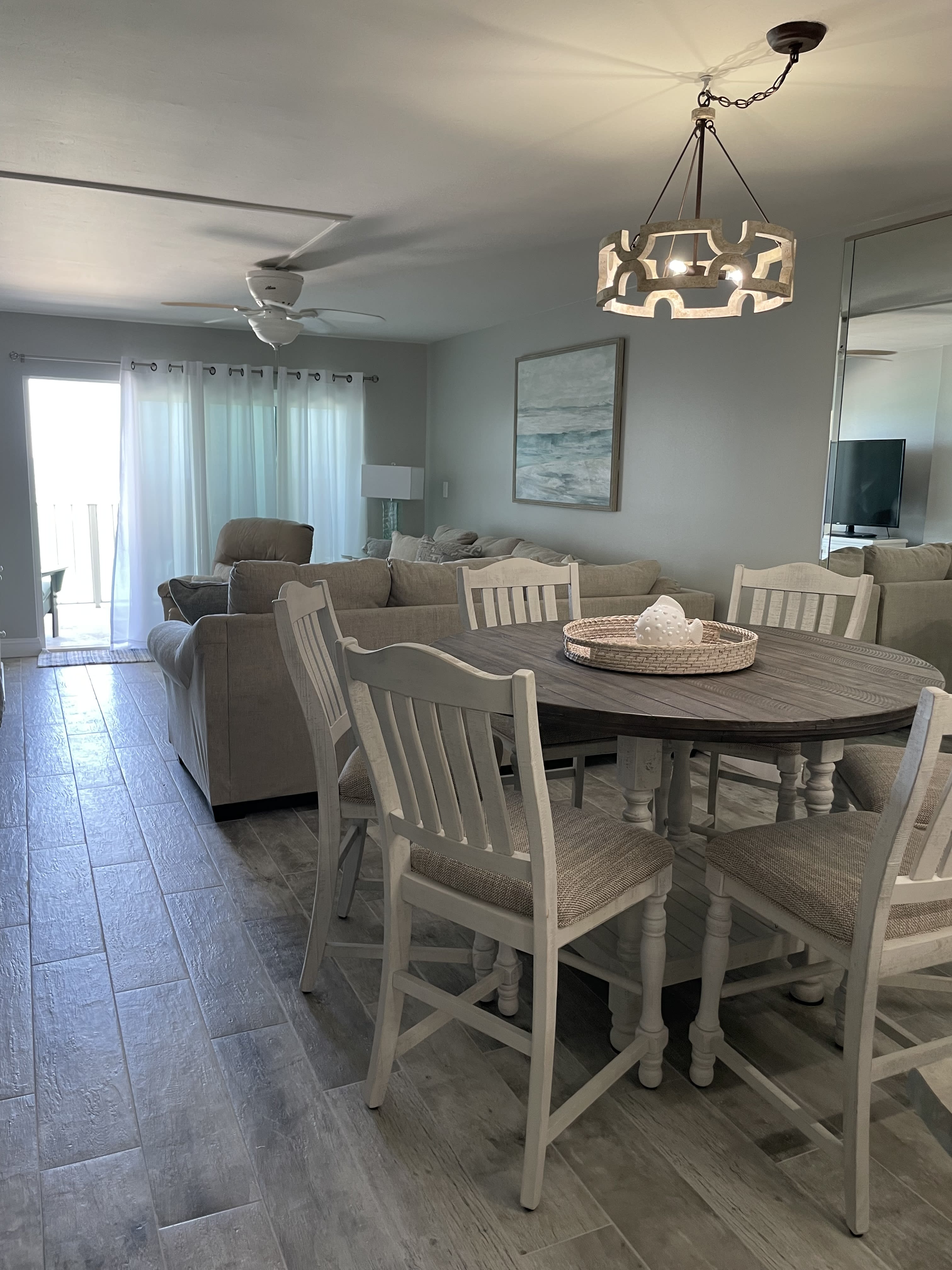 View from Dining Area to Living Area with Sliders to Balcony