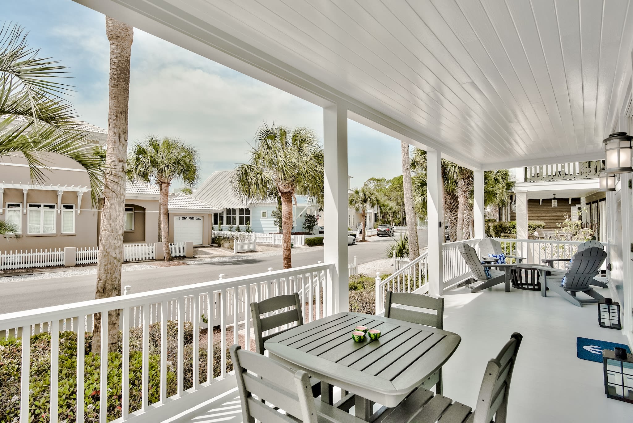 Spacious front porch with a dining table and lounge area