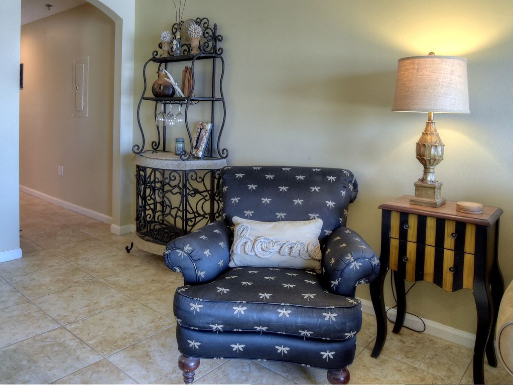Comfy chair and view of hall to front/entry door