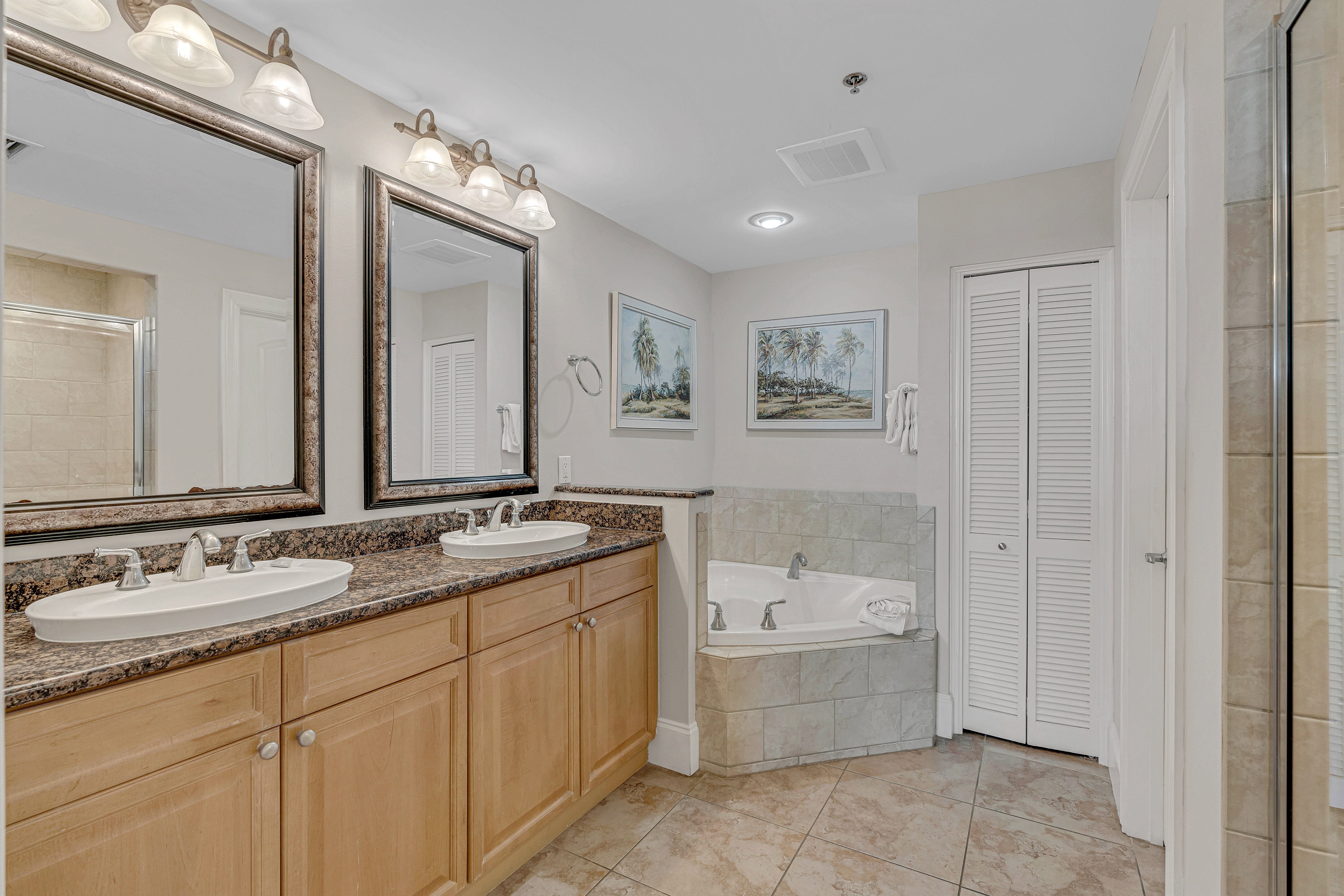 Private master bath with spacious vanity and fresh linens provided.