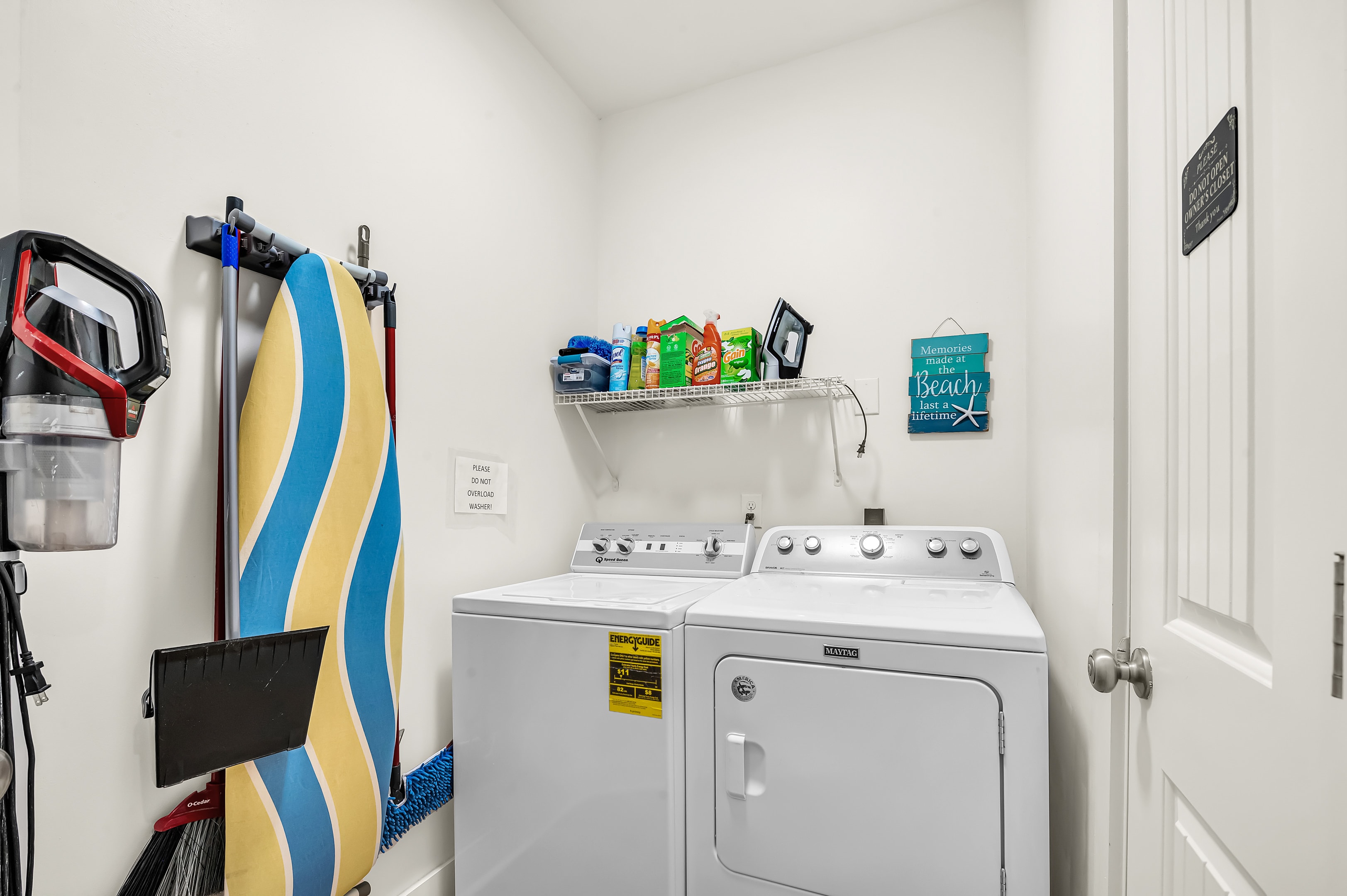 Laundry Room with Washer, Dryer, Ironing board, Iron.
