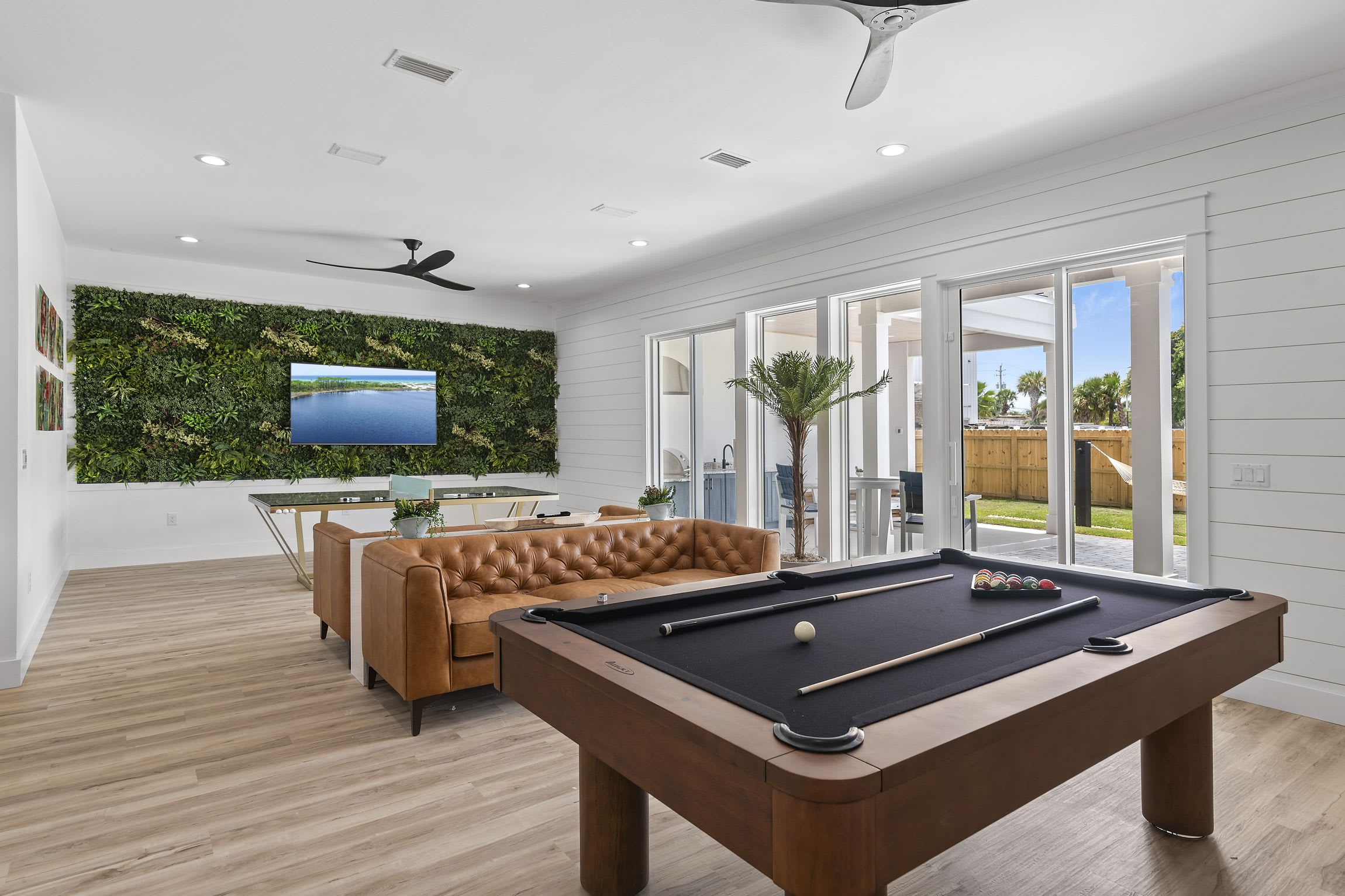 Entertainment area, featuring a custom glass ping pong table and a pool table.