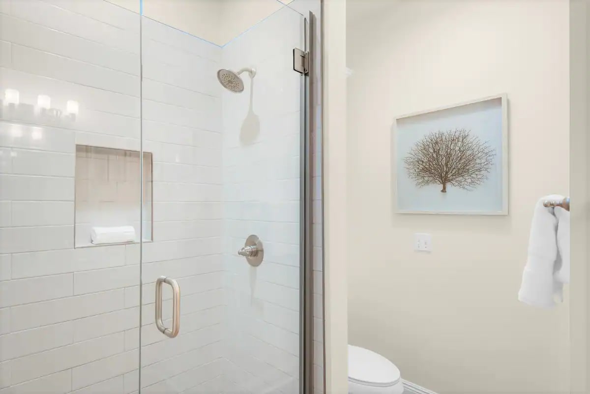 Shipwatch-17 Bedroom 1 private full bath. Photo 2. Quartz vanity and fameless glass, tiled shower.