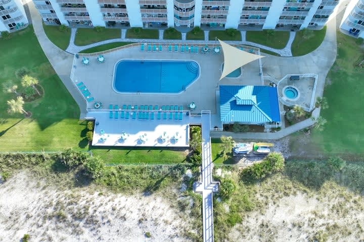 Aerial view of pool area with deck, kiddie pool and hot tub.