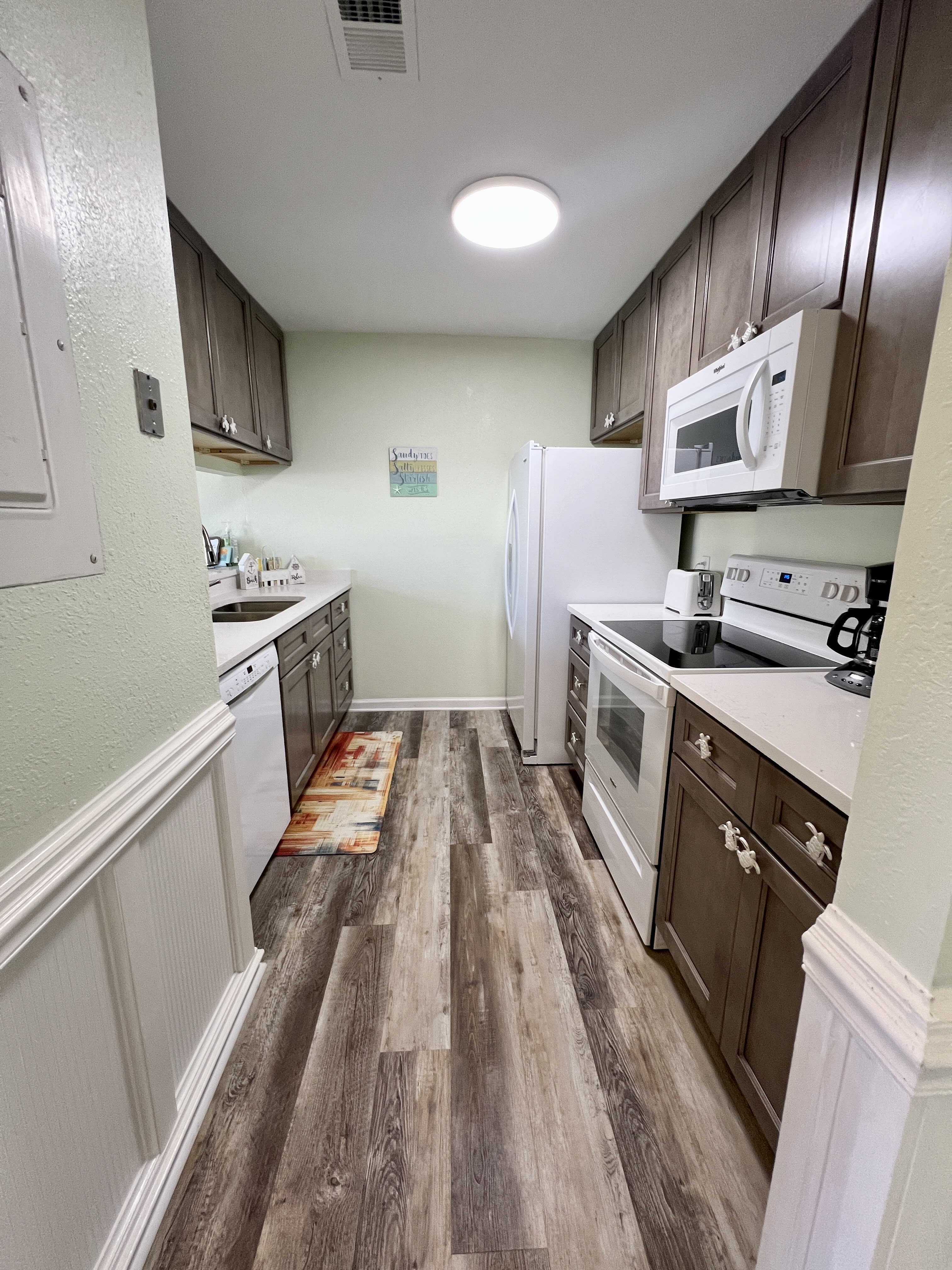 The galley kitchen is fully stocked with everything that you'll need.