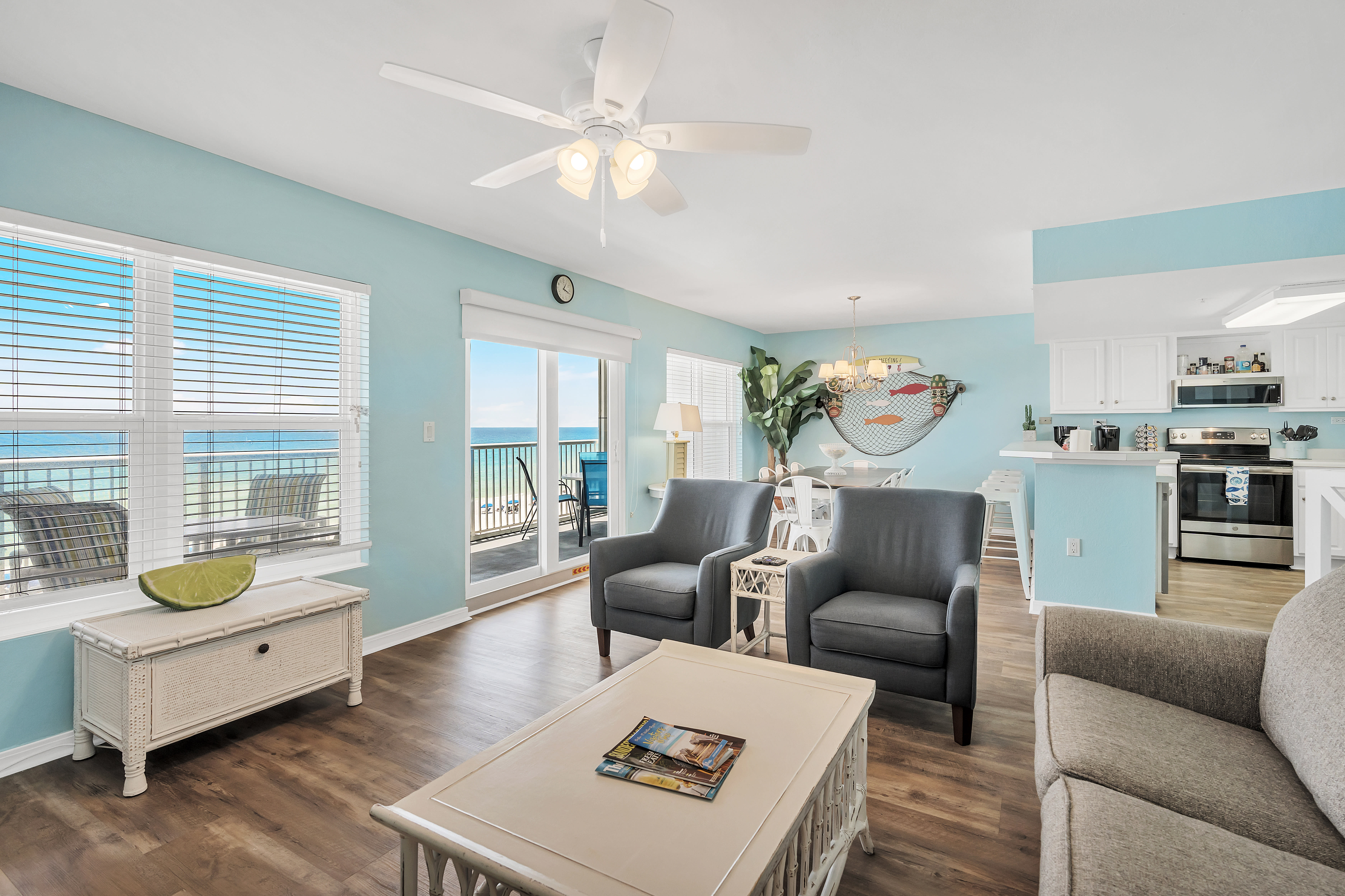 View of the beach, dining room, and kitchen from the living room.