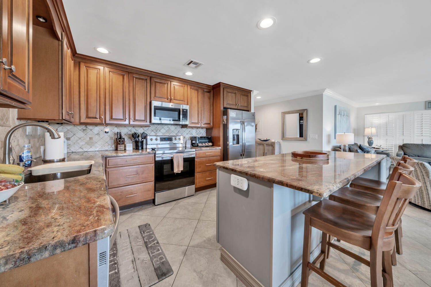 Kitchen, counter, and bar stools. 