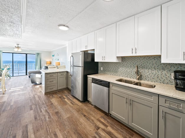 Fully stocked kitchen with beautiful tile backsplash.