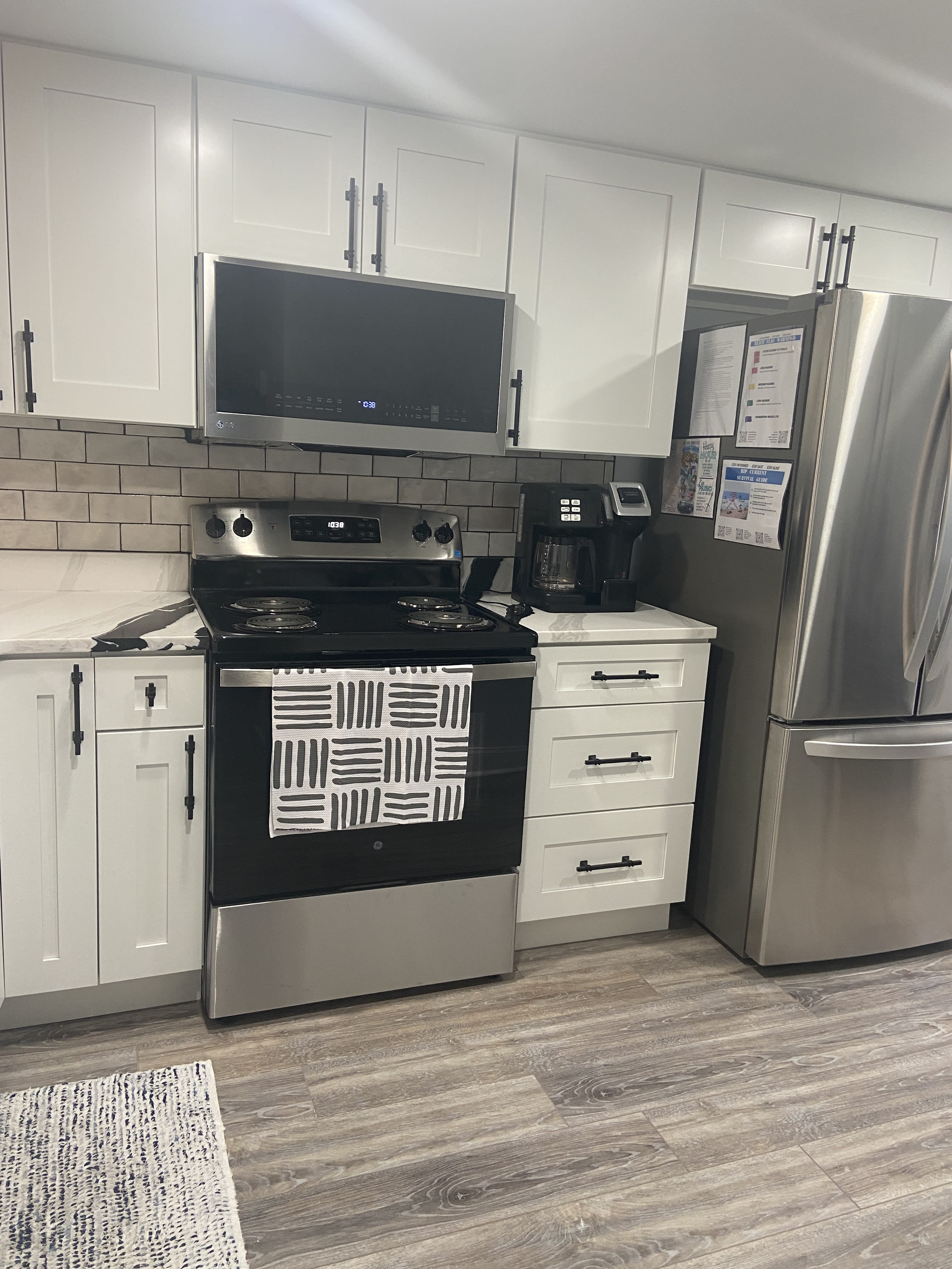 New stove and microwave complement the new cabinets and backsplash. 
