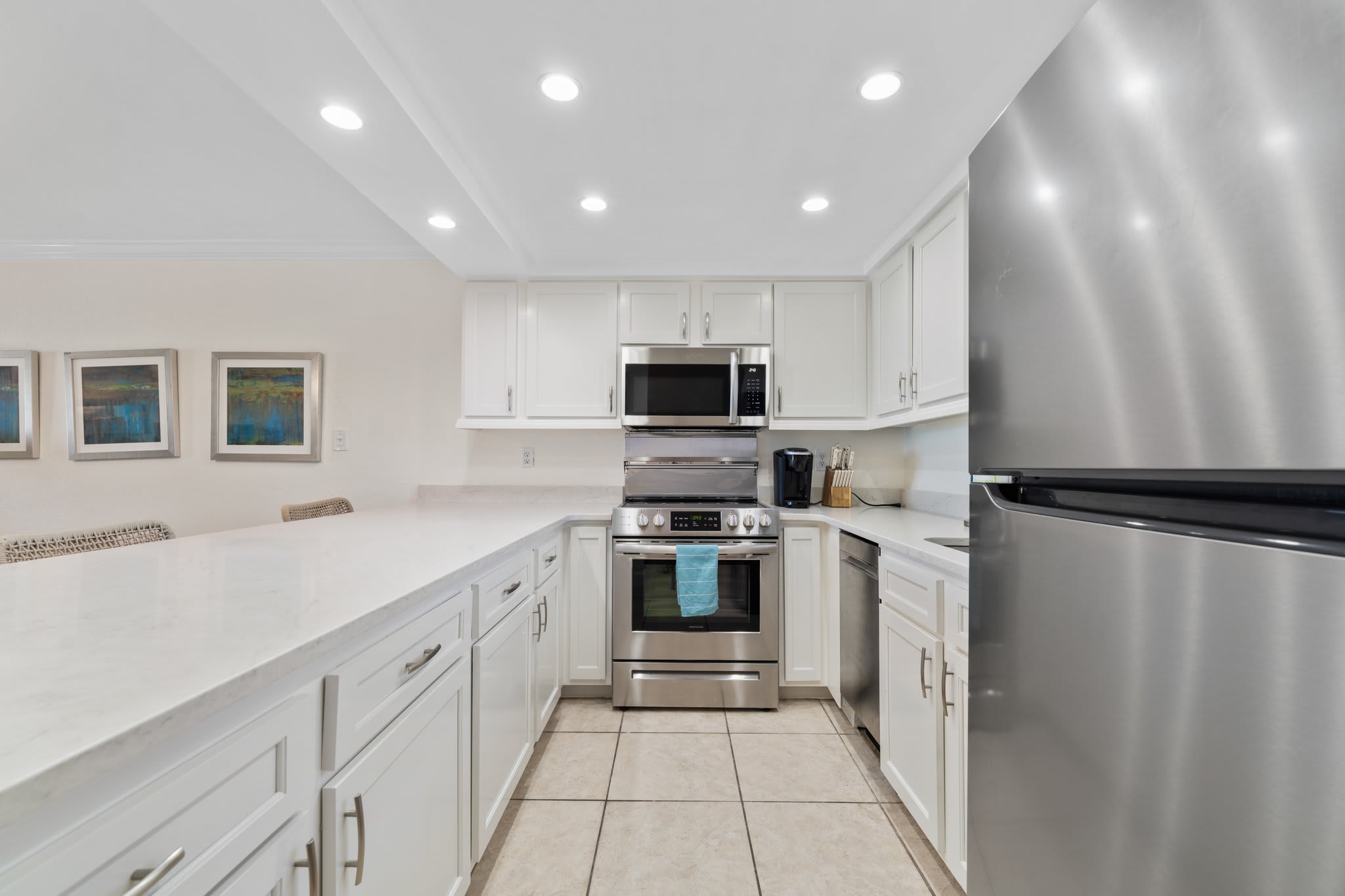 Well stocked kitchen with new stainless steel appliances.