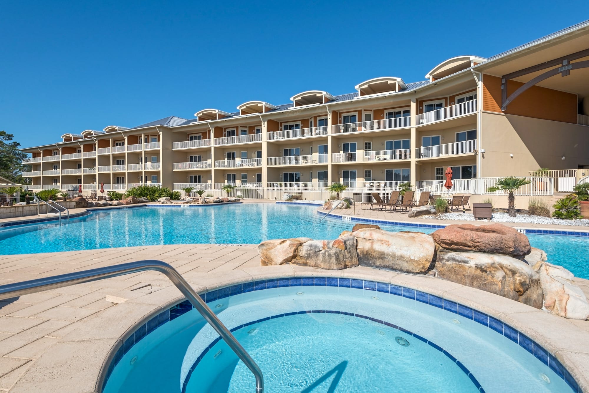 Expansive pool deck with a graduated pool entrance for little ones.