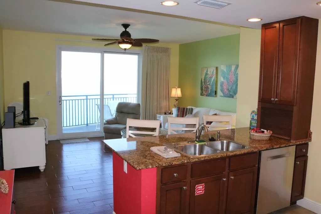 Kitchen, living area, and balcony overlooking ocean