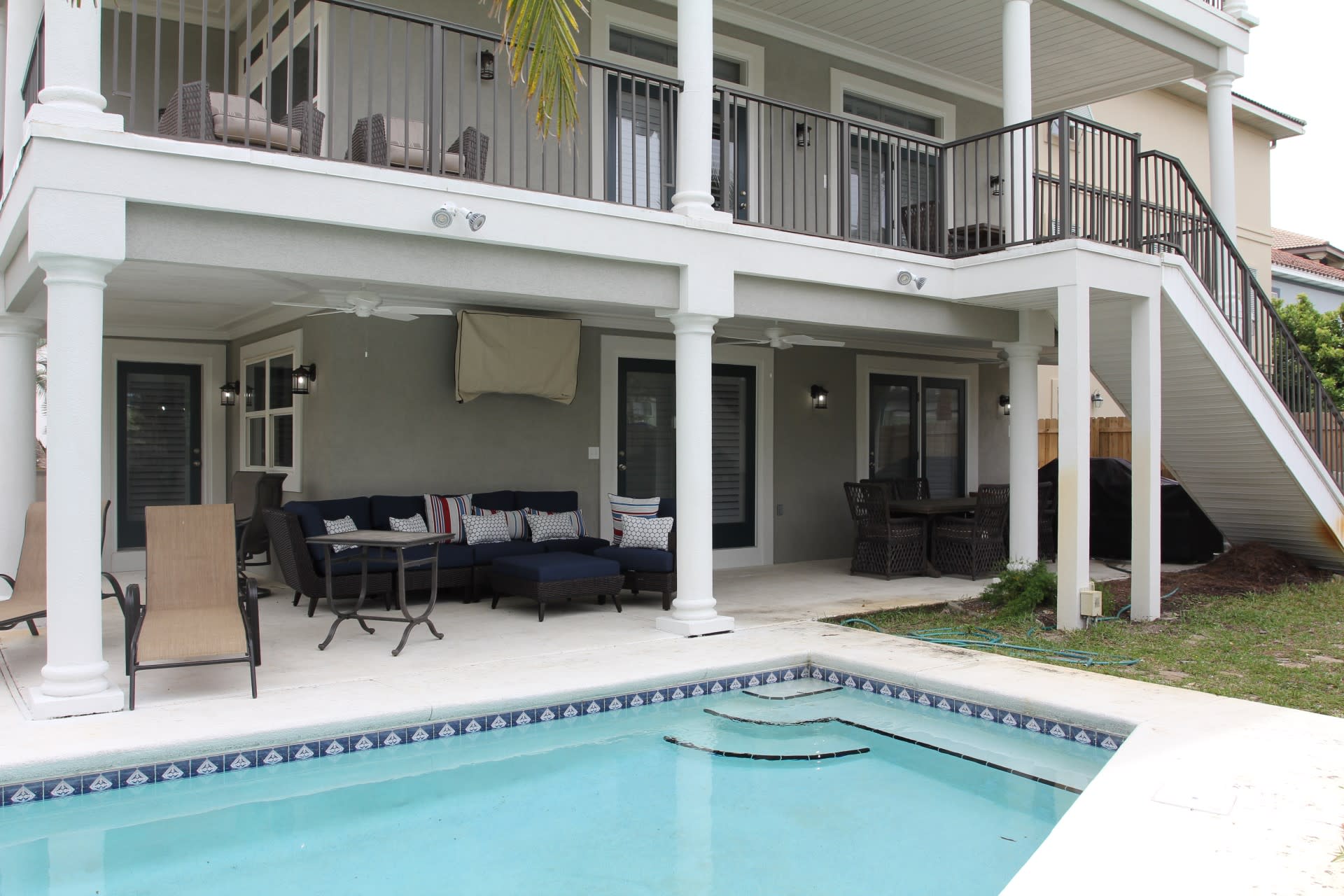 Pool area, group seating, TV, Kitchenaid outdoor grill center, 2 seated dining areas