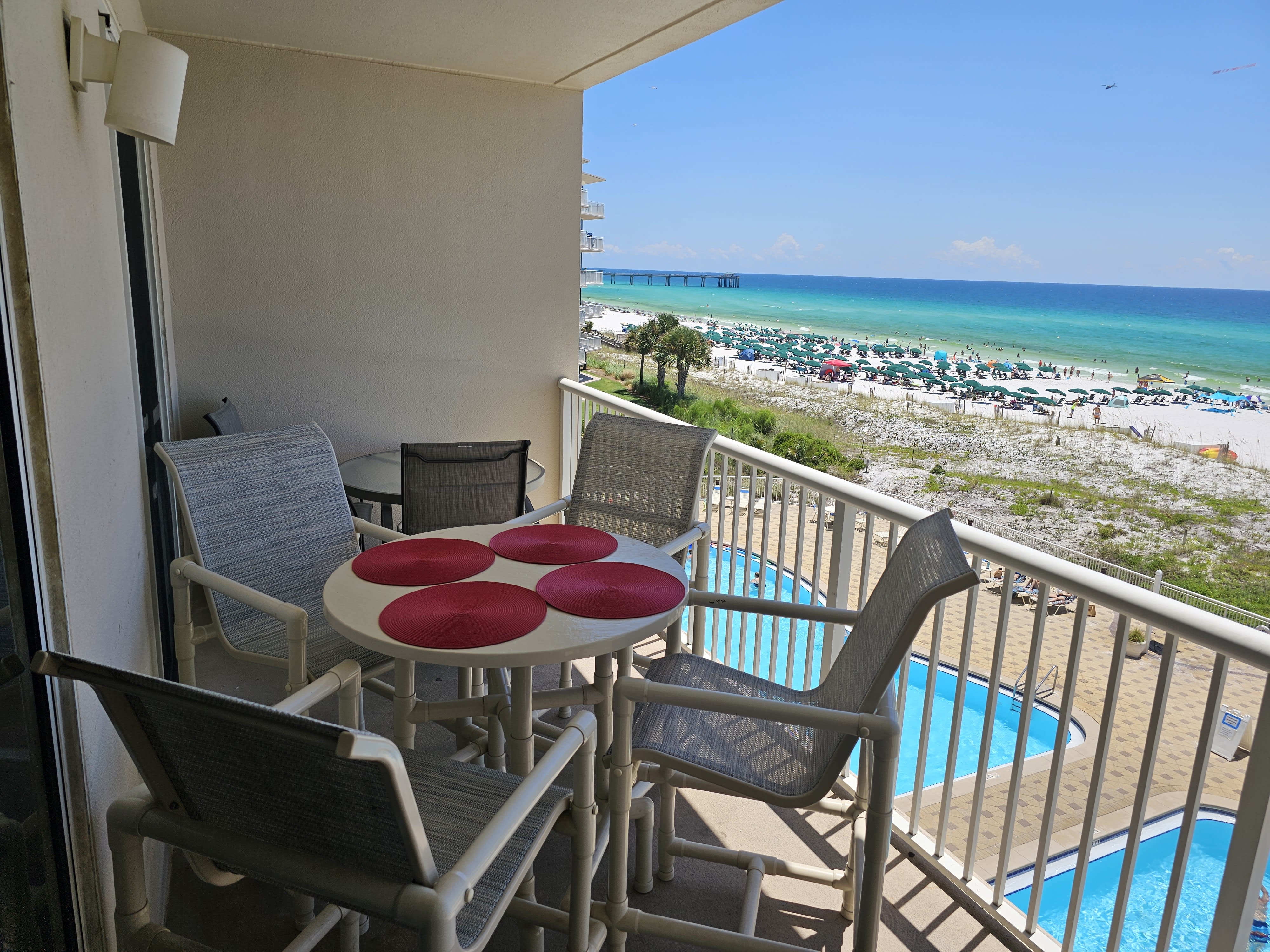 Large balcony with 2 dining tables, chaise lounge, and gorgeous views