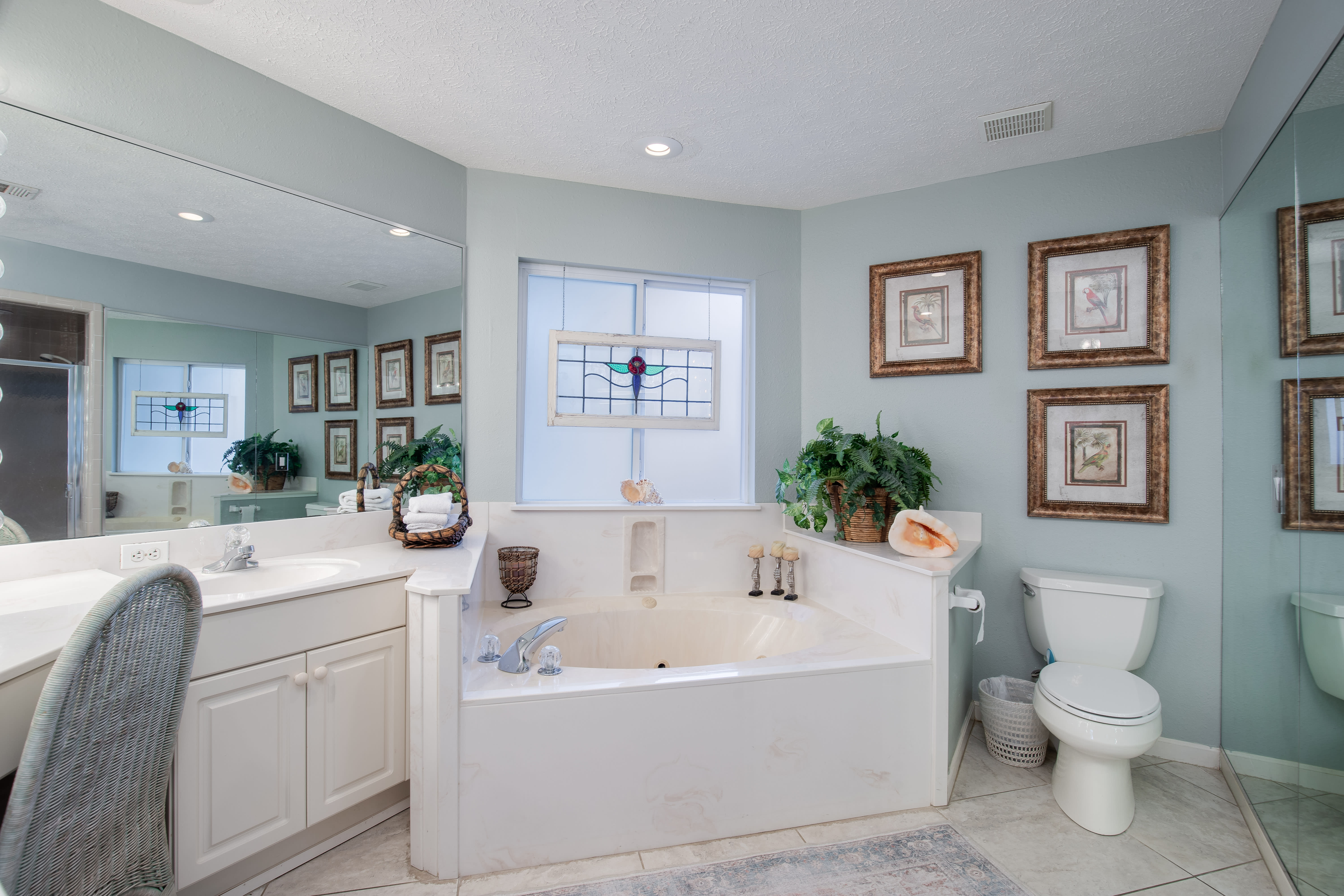 Master bathroom offers dual vanities, walk-in shower, and soaking tub.
