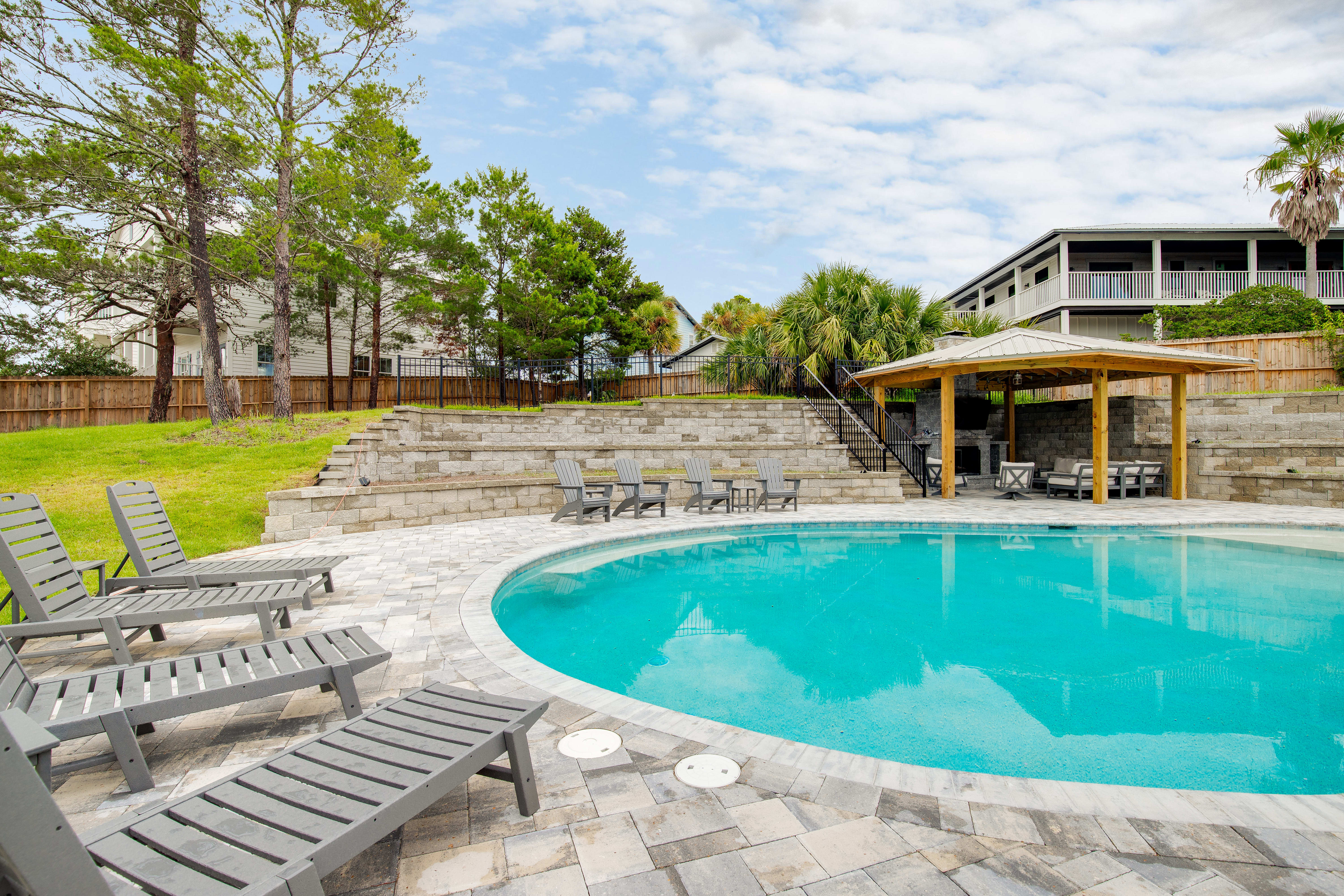 Pool can be optionally heated. Outdoor fireplace and stairs to putting green.