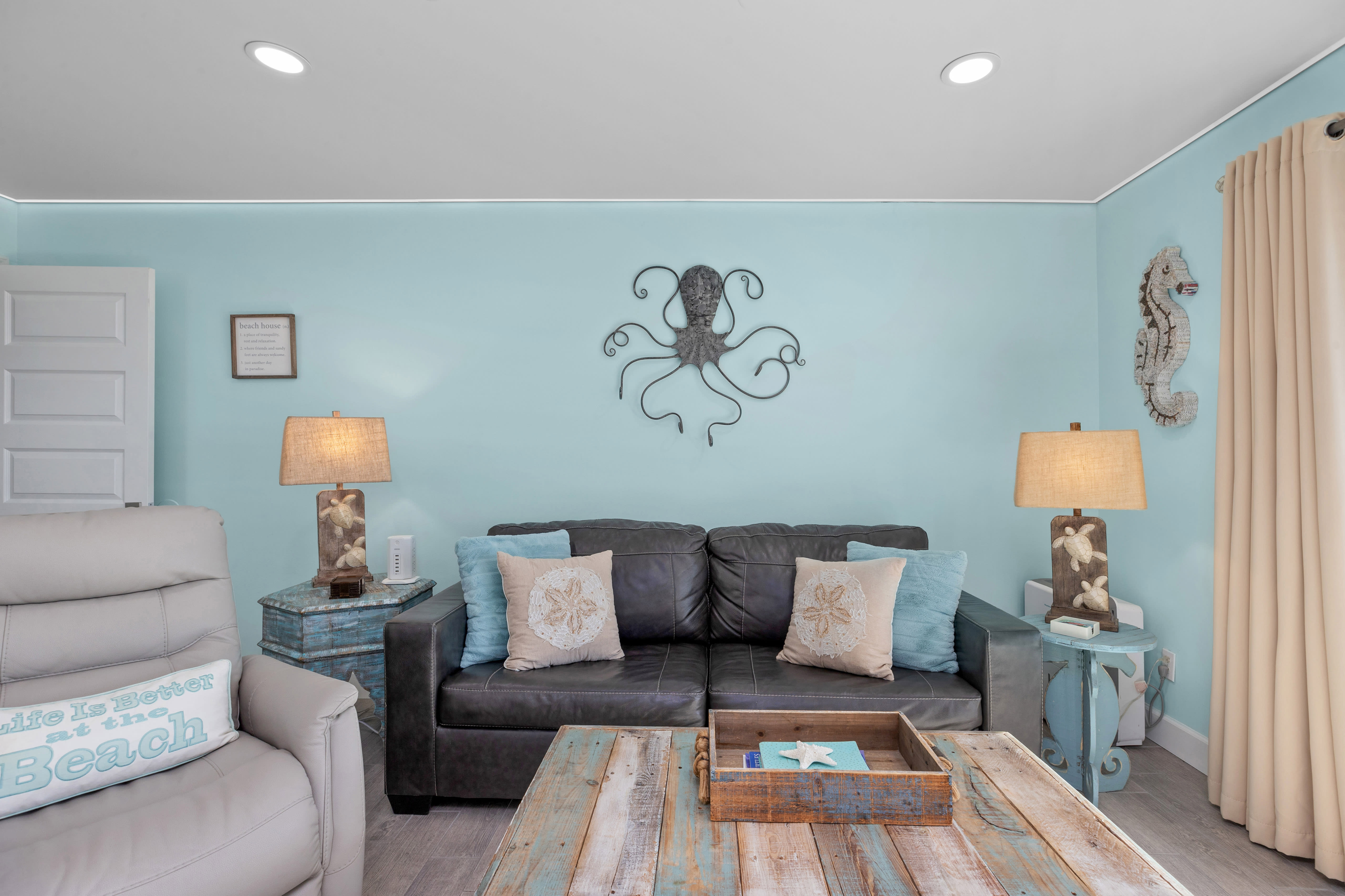 Living area offers a leather sofa sleeper; recliner; 65 inch TV &amp; PS5