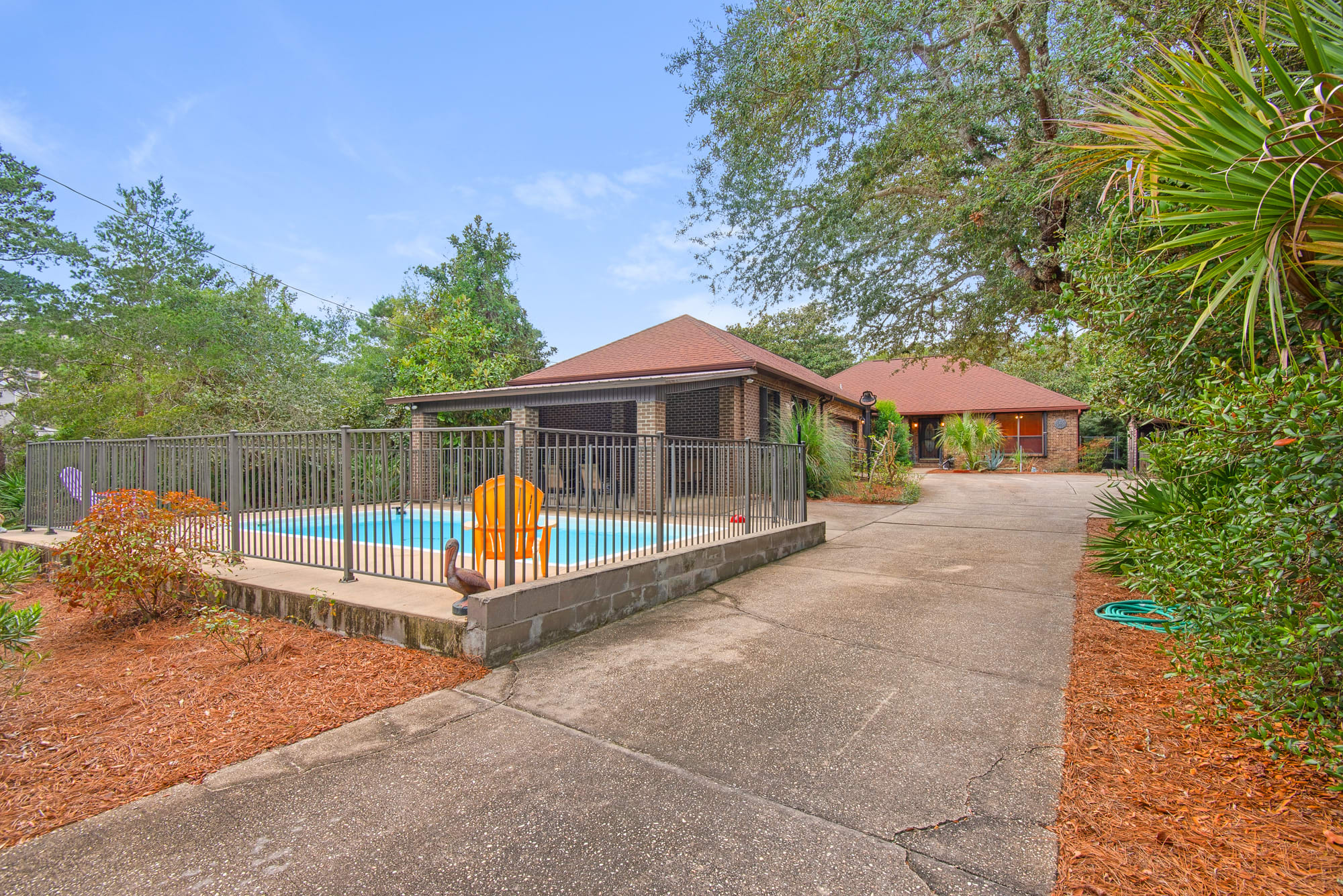 Pool with covered patio for grilling and enjoying family outdoors