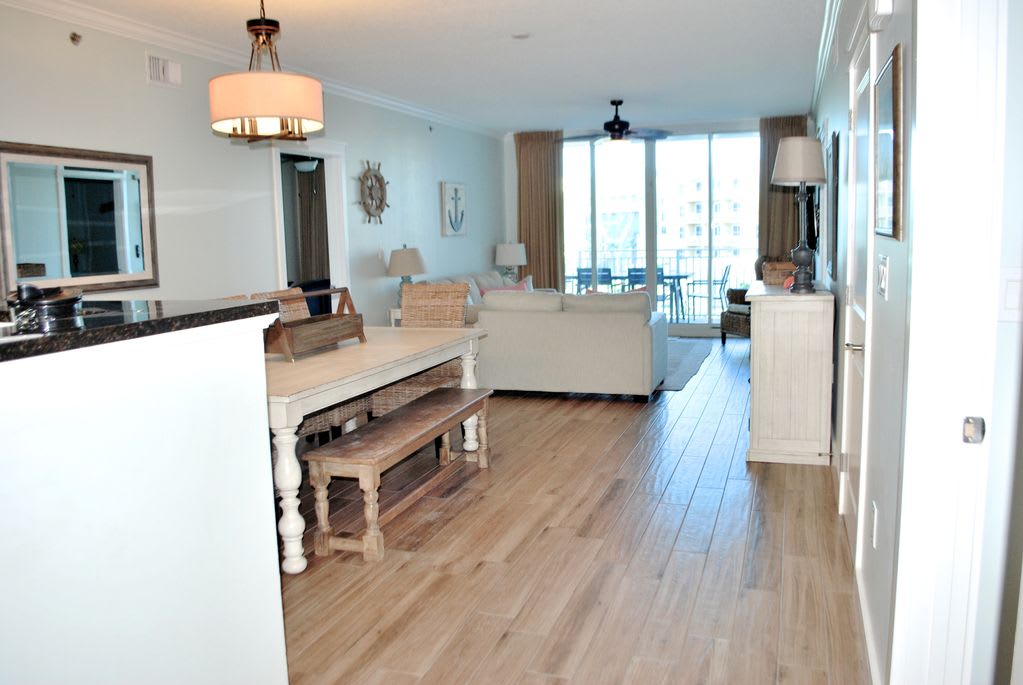 view from entryway. Newly installed wood look tile throughout living and dining