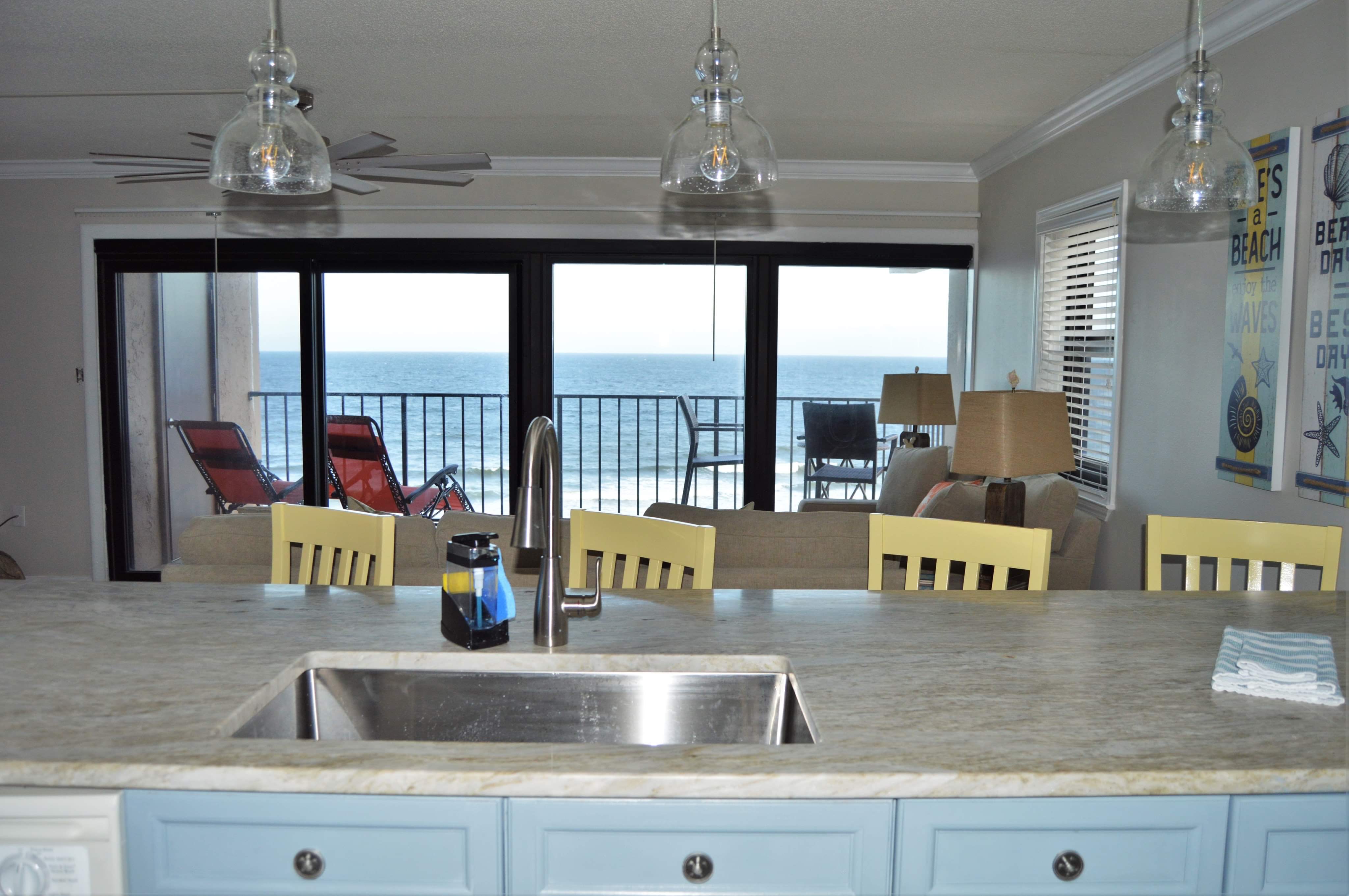 Gulf view from kitchen, new quartzite countertop &amp; pendants.