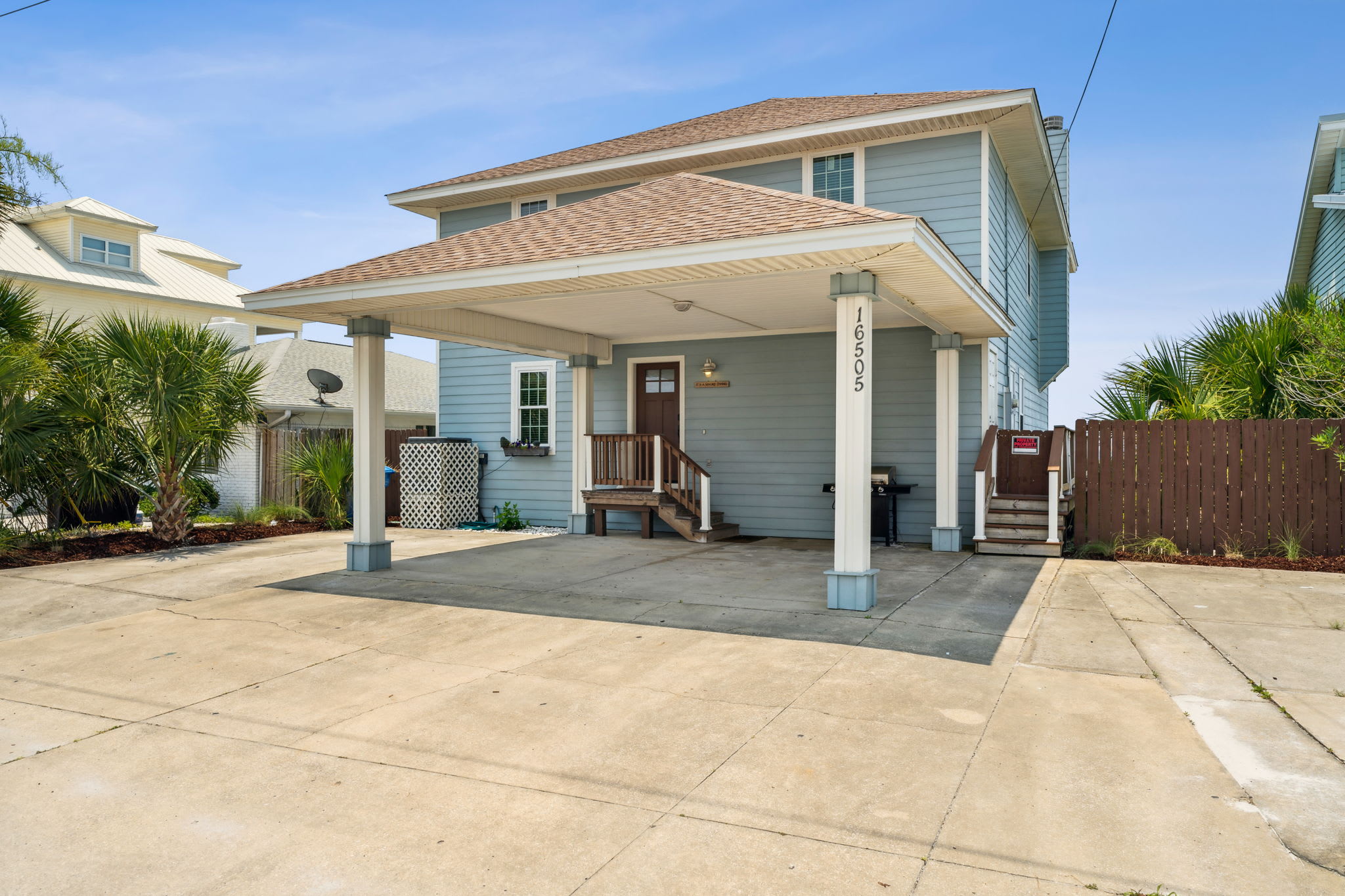 Front of the house showing covered parking and parking area