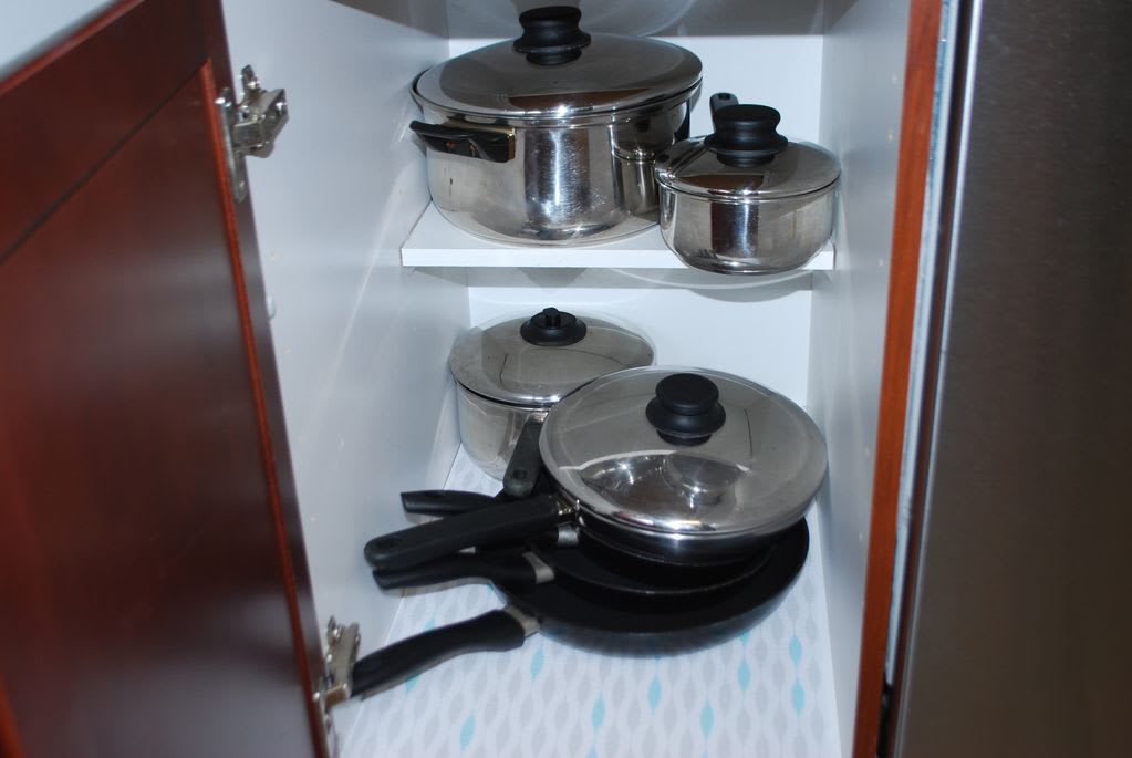 kitchen fulling stocked with pots , pans , dishes , utensils. etc.