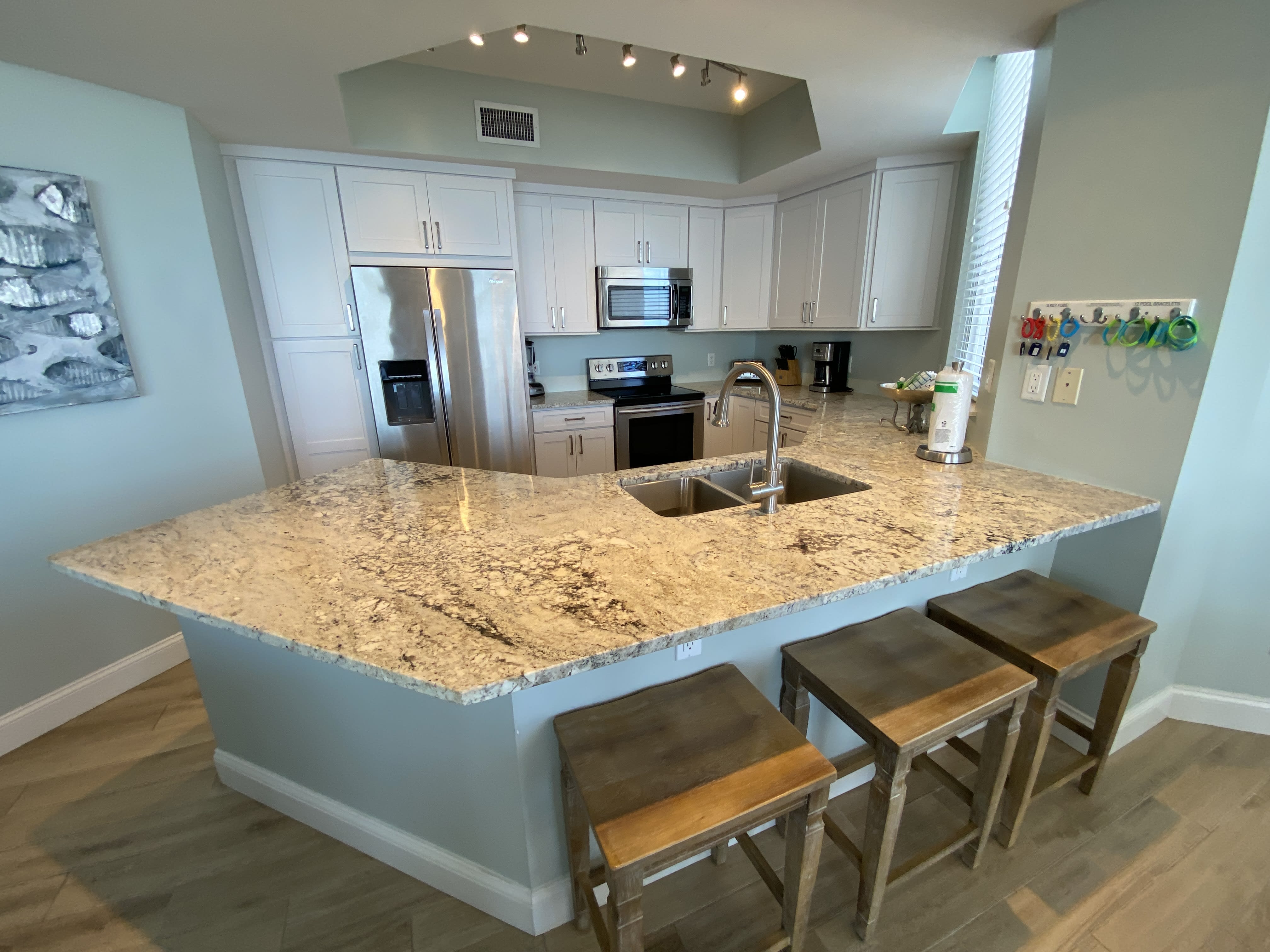 Custom white shaker kitchen with white ice granite counters.