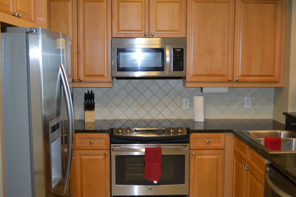 Modern, fully outfitted kitchen, with marble counter tops
