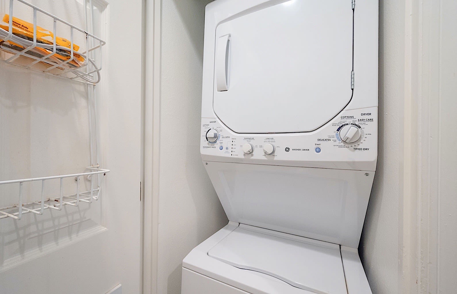 Stacked washer/dryer unit located in the hall laundry closet