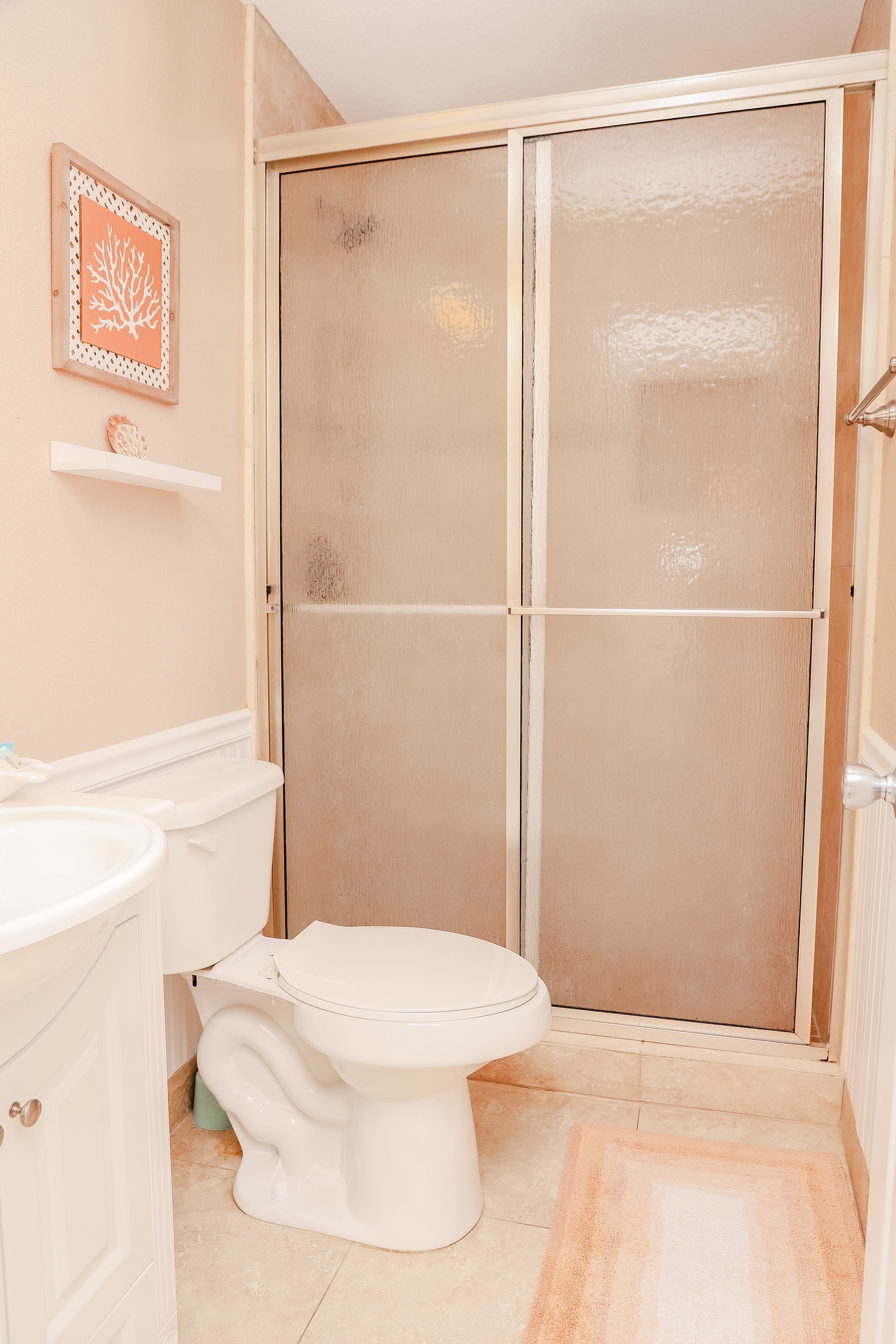 The queen bedroom offers a private bathroom with a tiled, walk-in shower.